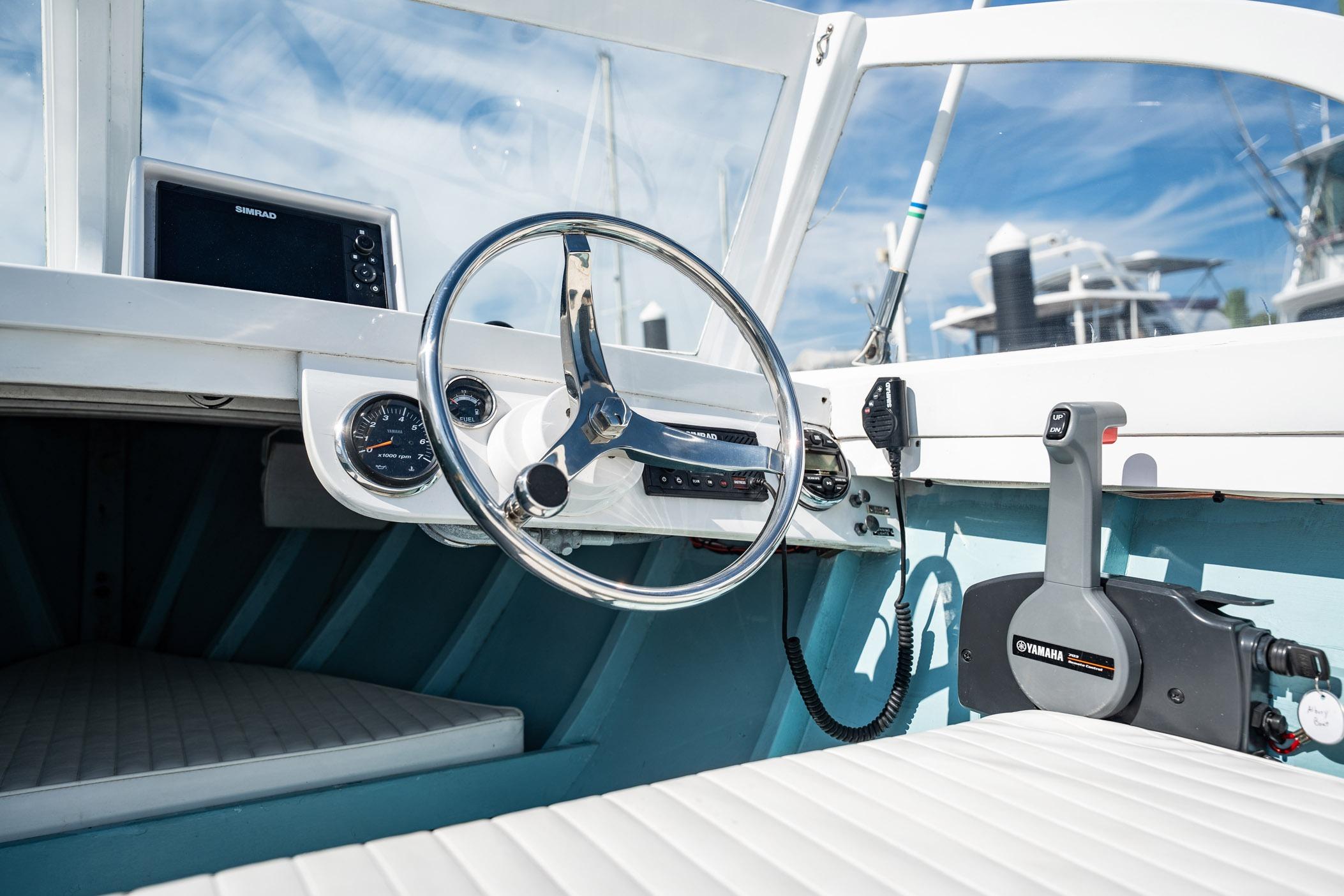 Interior of a 1982 Albury Brothers Runabout boat with steering wheel and controls.