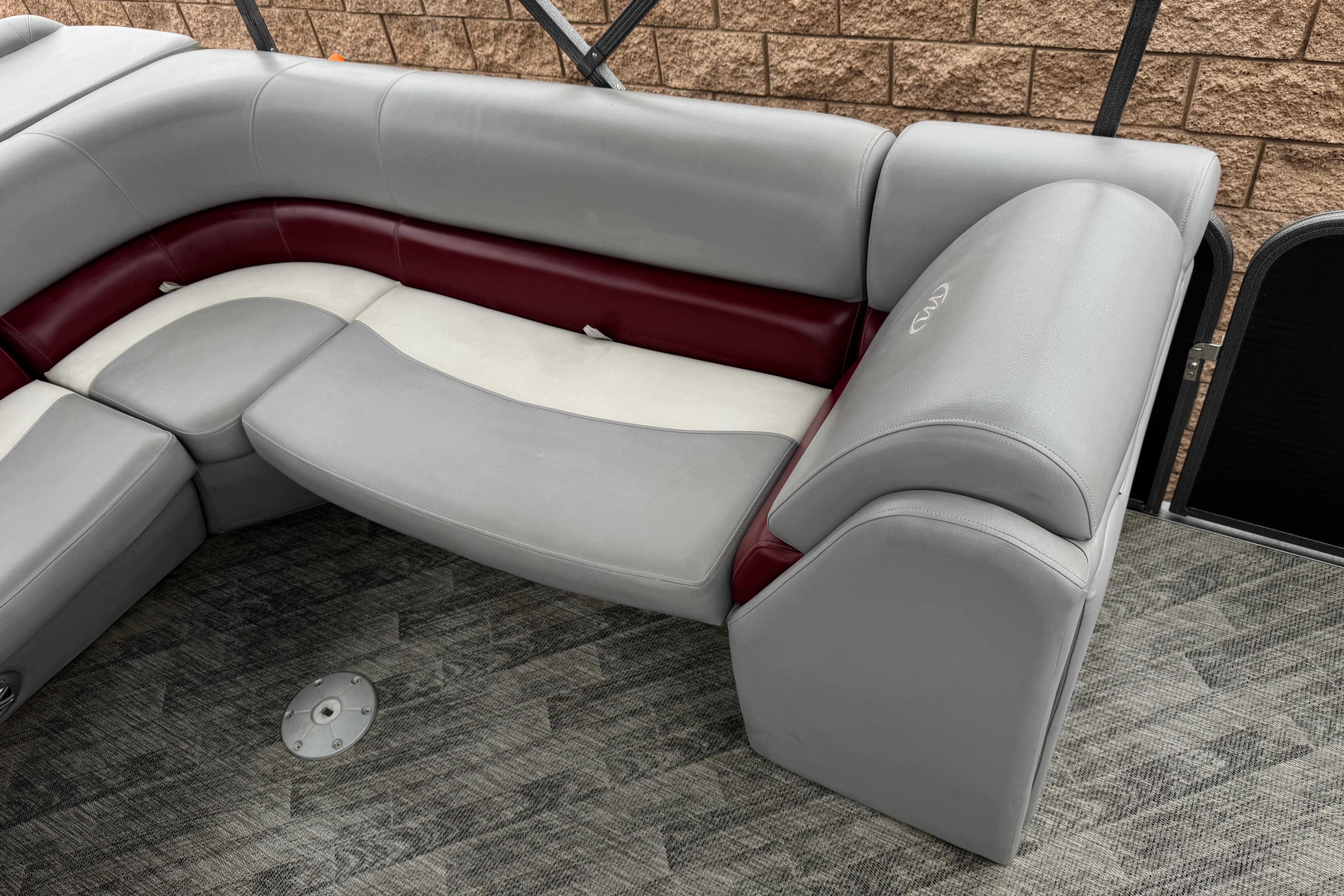 2020 Manitou 18 Aurora LE boat interior with gray and maroon seating.