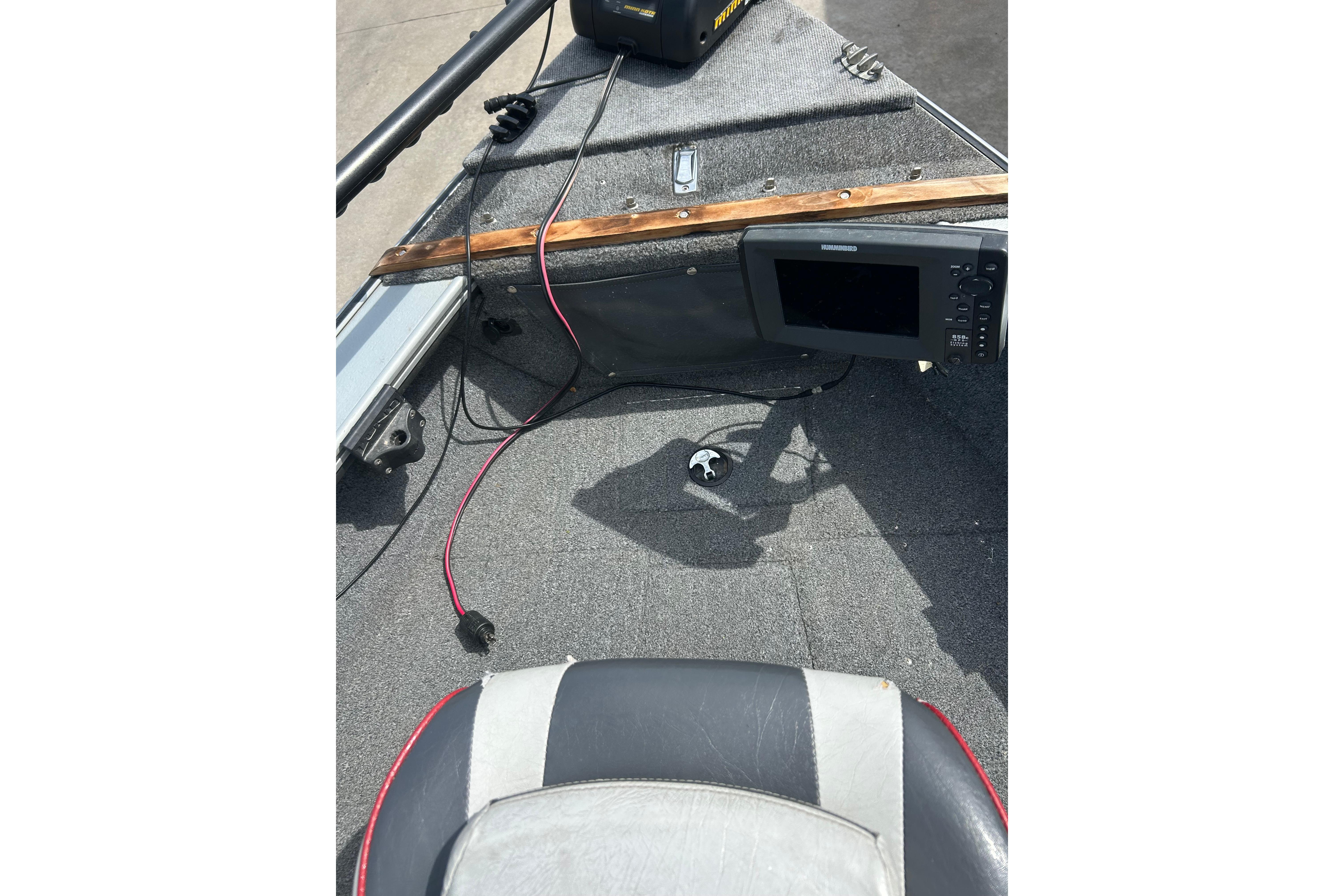 2008 Lund 1850 Fisherman boat interior with electronic equipment and seating.