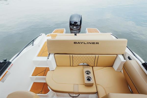 Manufacturer Provided Image: 2025 Bayliner D20 boat interior with tan seating and cup holders on calm water.
