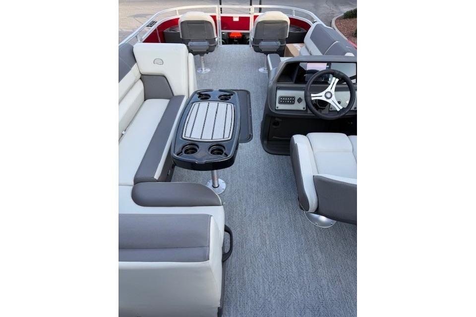 2026 Sun Tracker Fishin' Barge 22 XP3 interior with seating, table, and steering console.