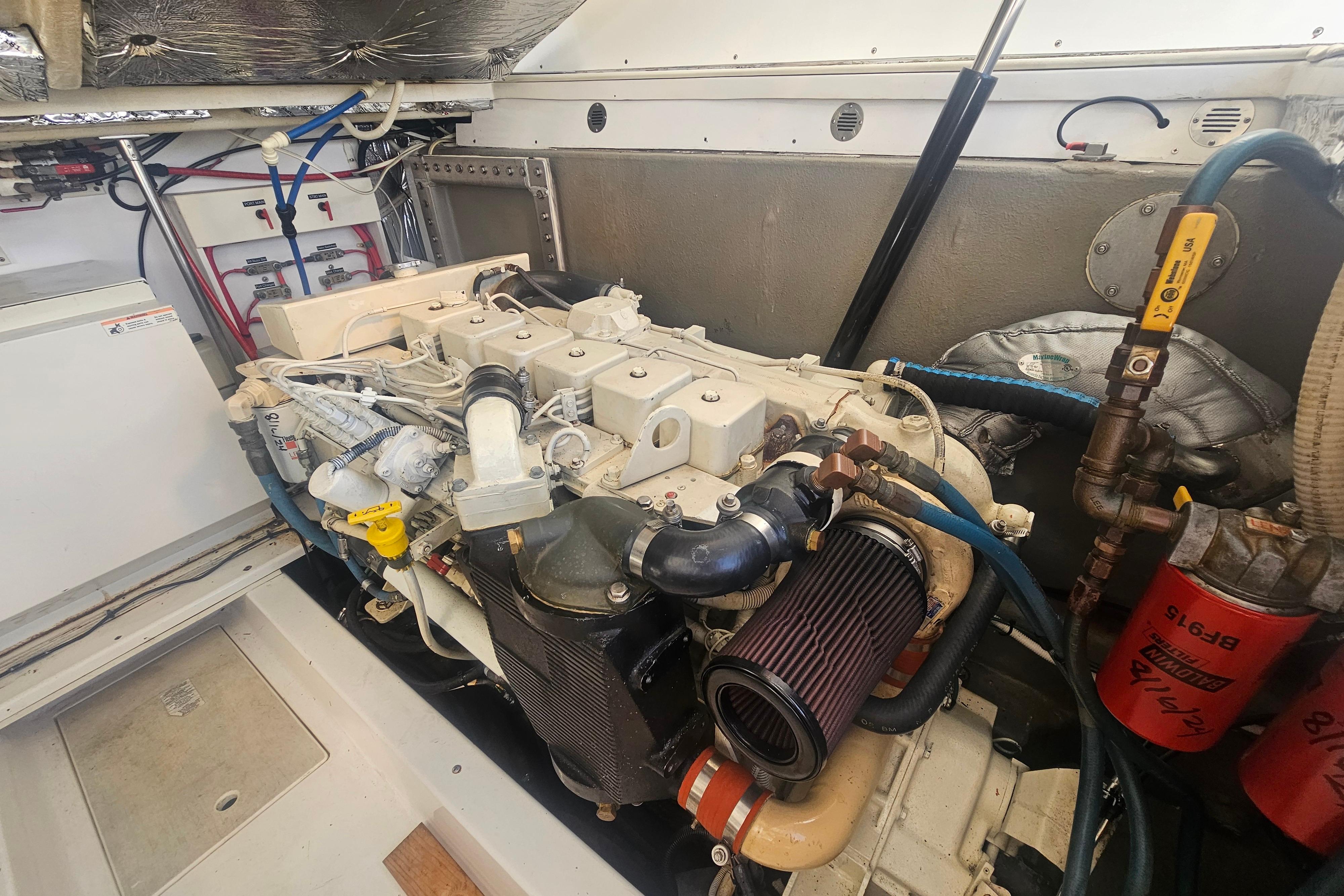 Engine room of a 2003 Topaz 32 Express boat, showcasing detailed machinery.