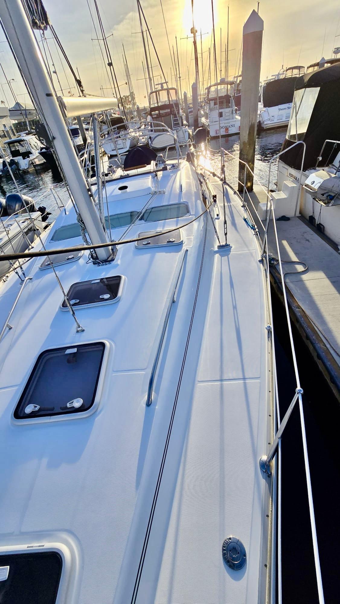 Beneteau 393 sailboat, 2006 model, docked at sunset with visible deck and rigging.