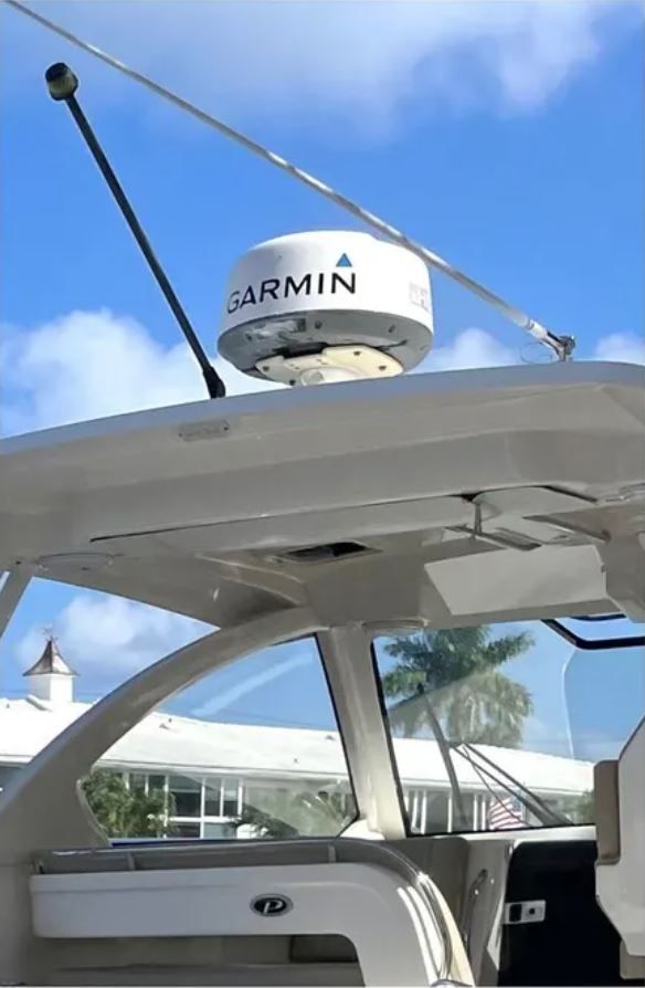 2016 Pursuit OS 325 Offshore with Garmin radar under blue sky.