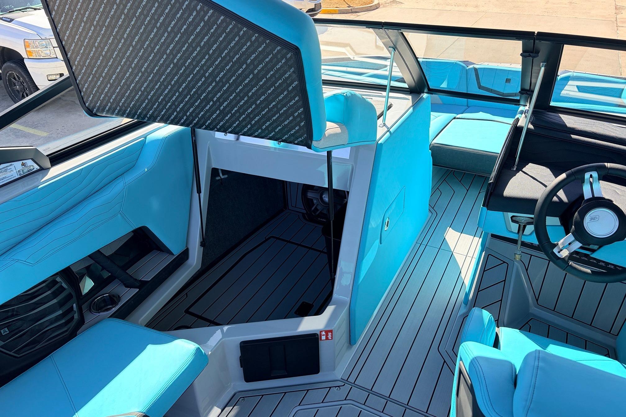 Interior of 2026 Nautique Super Air Nautique G23, featuring sleek blue seating and modern design.