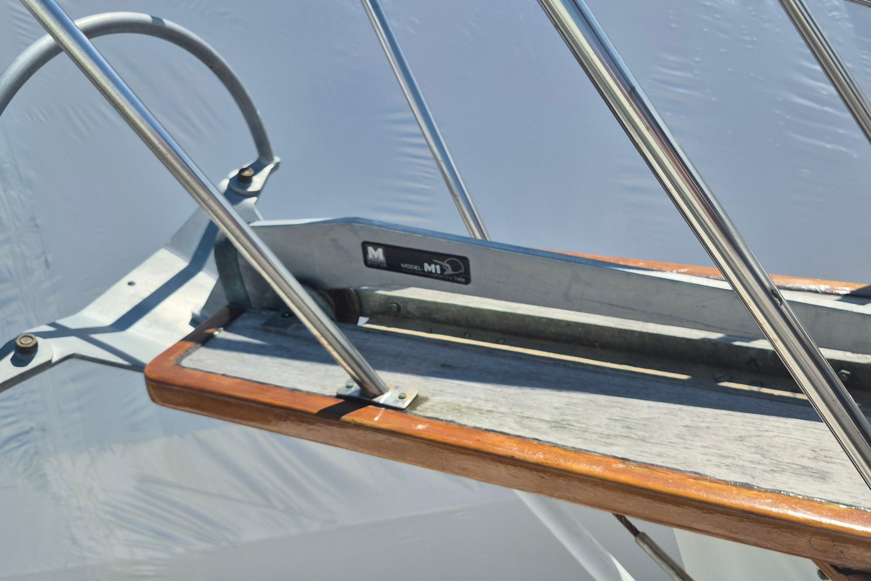 Close-up of 1983 Grand Banks 42 Motoryacht's metal and wood railing detail.