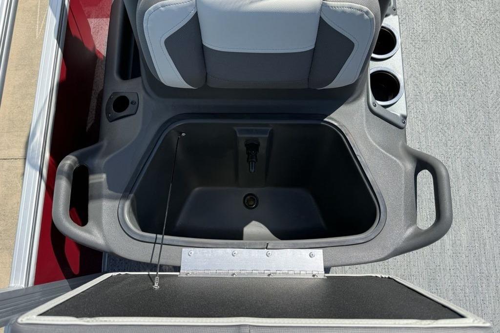 Storage compartment on 2026 Sun Tracker Bass Buggy 18 DLX boat with cup holders.