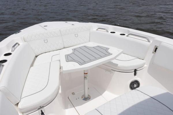 Manufacturer Provided Image: 2025 Sea Fox 268 Commander boat with white seating and table on calm water.