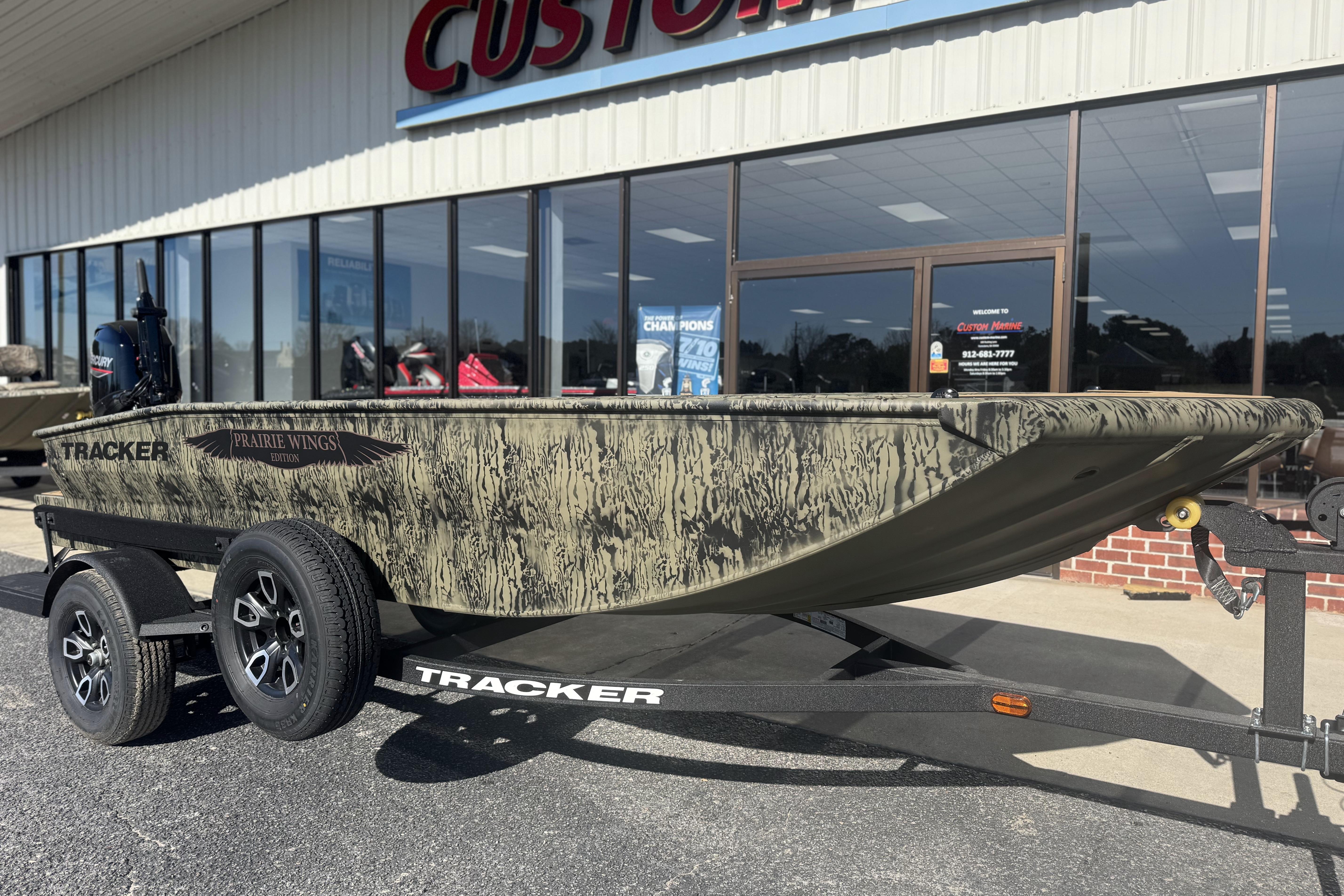 2026 Tracker Grizzly 1650 T Prairie Wings Edition boat on trailer outside dealership.
