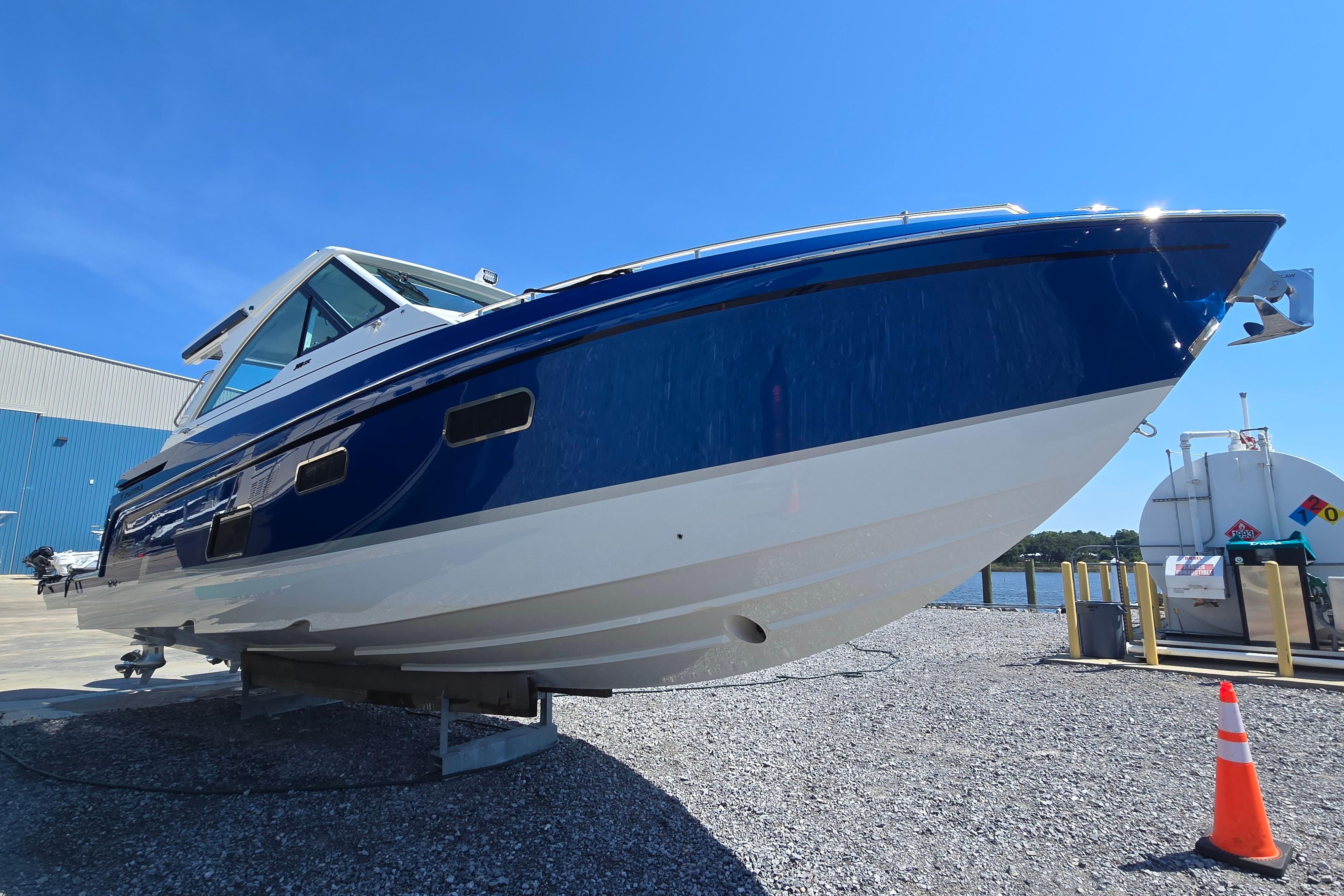 2025 Formula 380 Super Sport Crossover OB boat on display, blue and white hull.