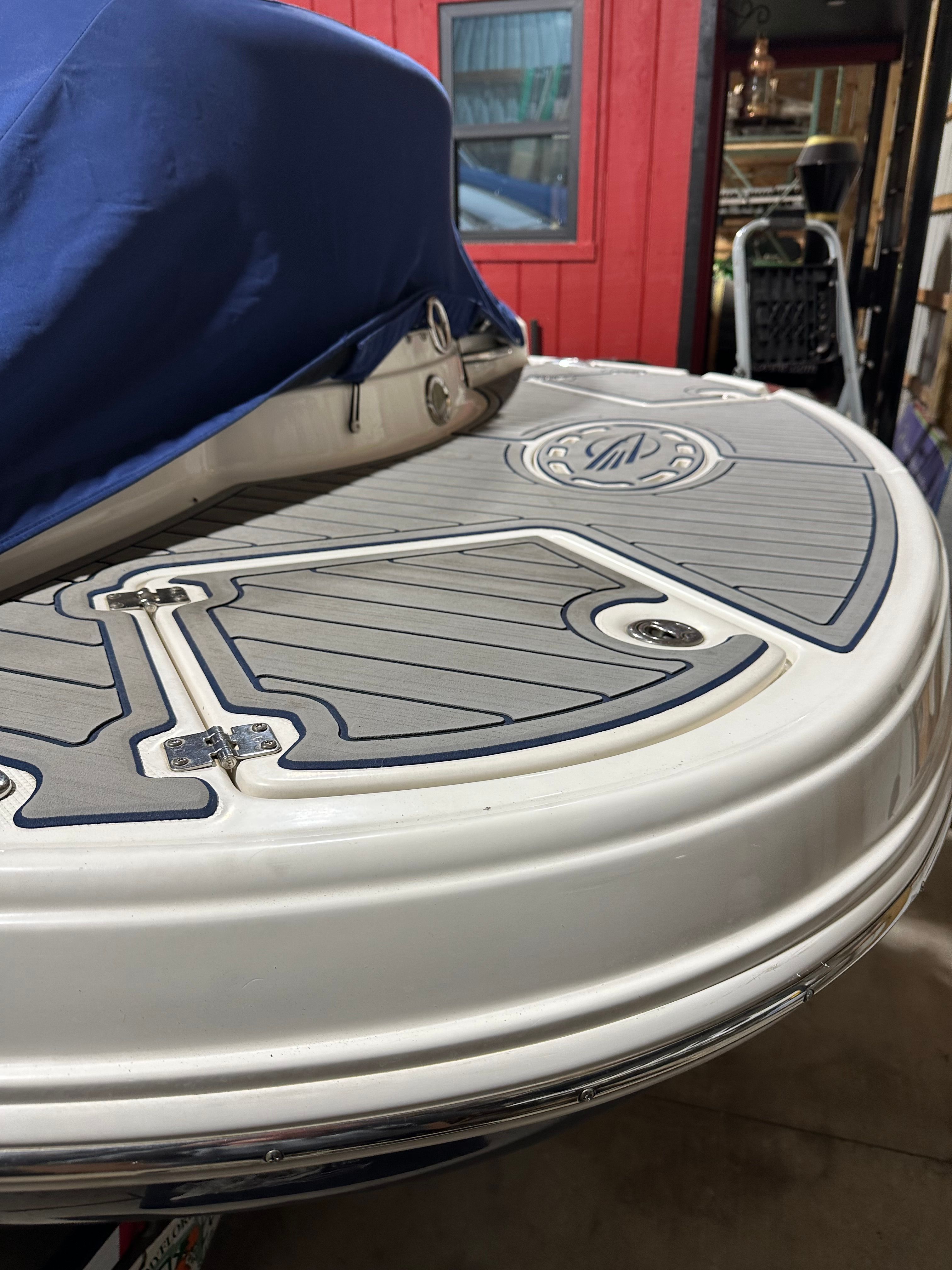 The image shows the stern of a Chaparral 287 SSX boat with a textured platform.