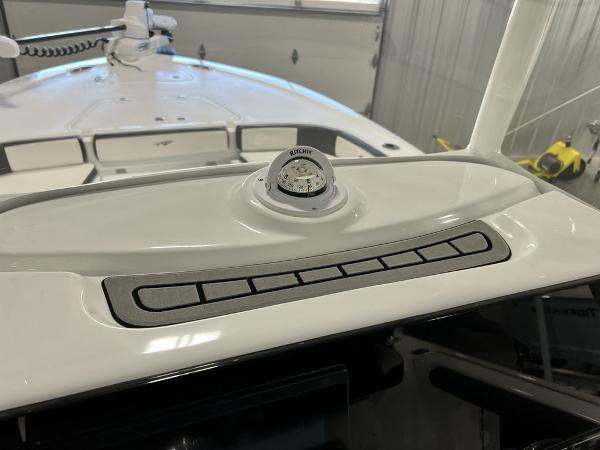 2025 Tidewater 2300 Carolina Bay boat dashboard with compass and control panel.