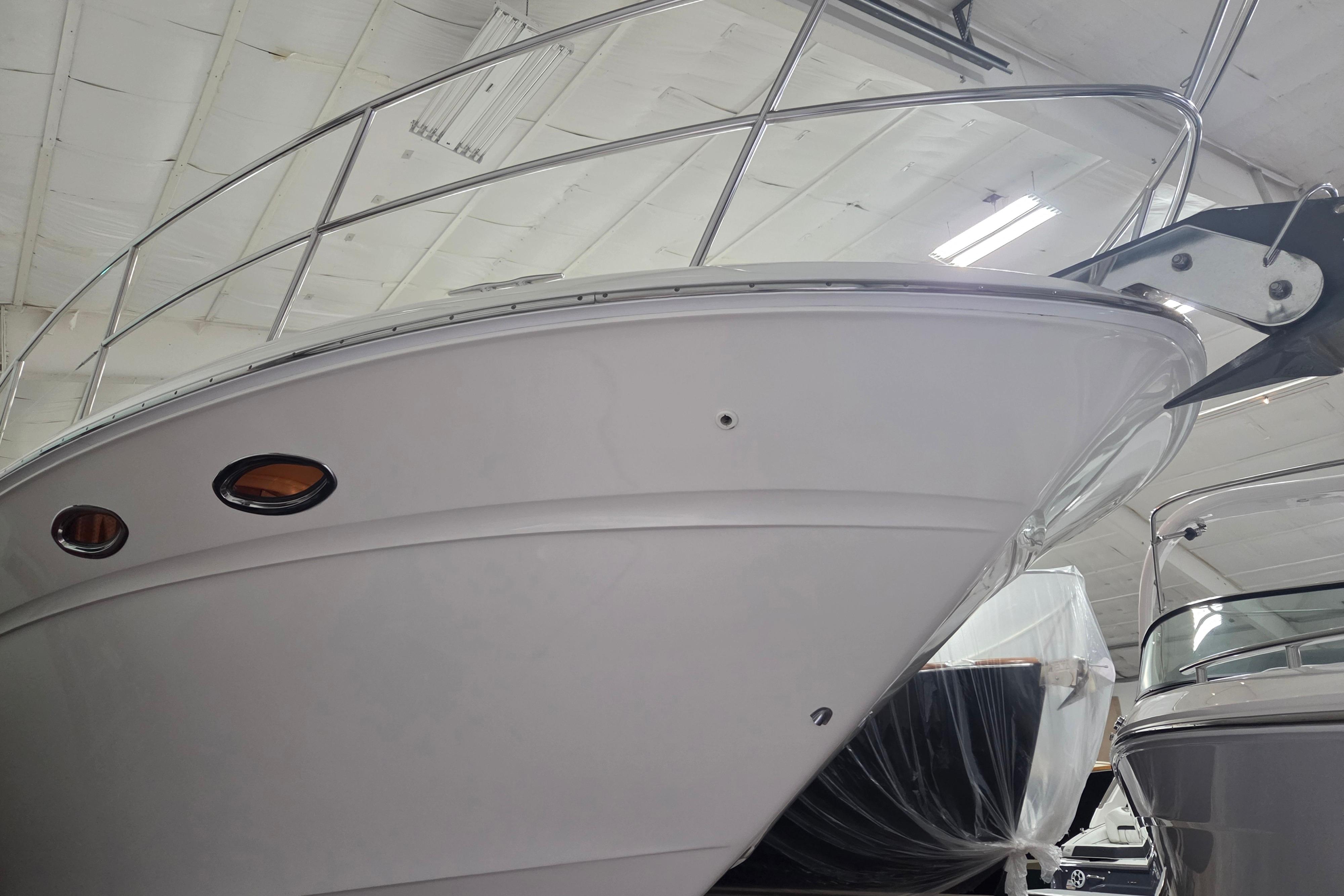 2000 Sea Ray Sundancer 540 yacht in indoor storage, showcasing sleek design and polished exterior.