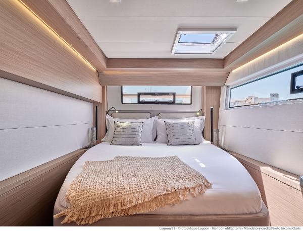 Luxurious bedroom interior of 2025 Lagoon 51 ICONIC yacht with modern design and natural lighting.