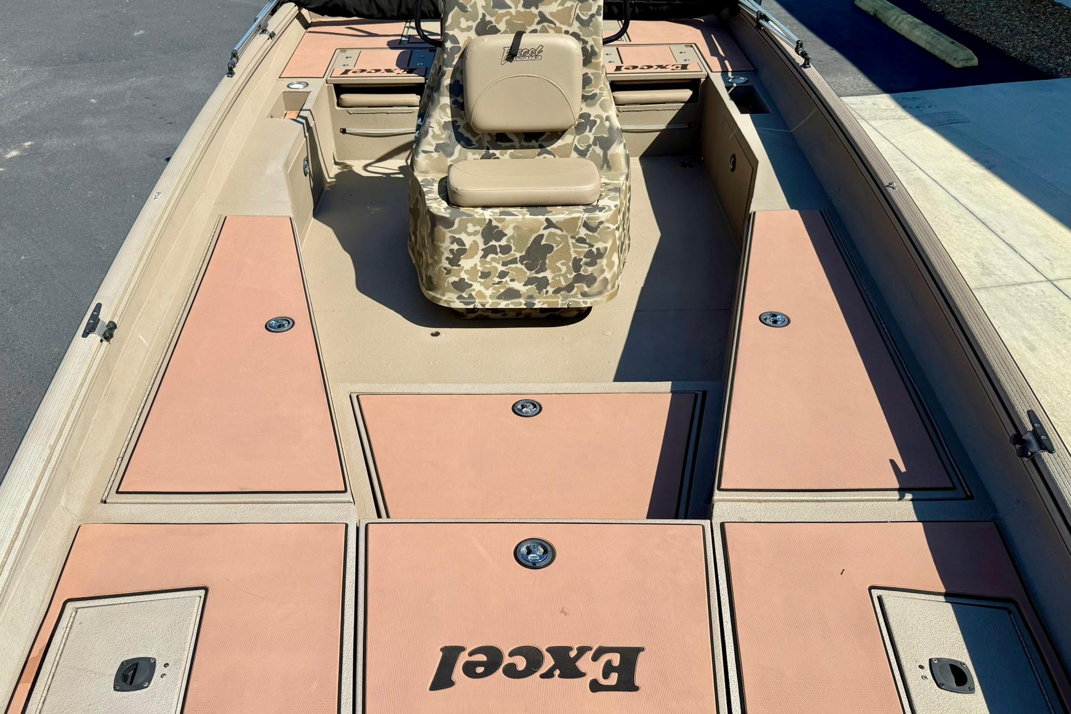 2019 Excel 230 Bay Pro boat interior with camouflage seating and storage compartments.
