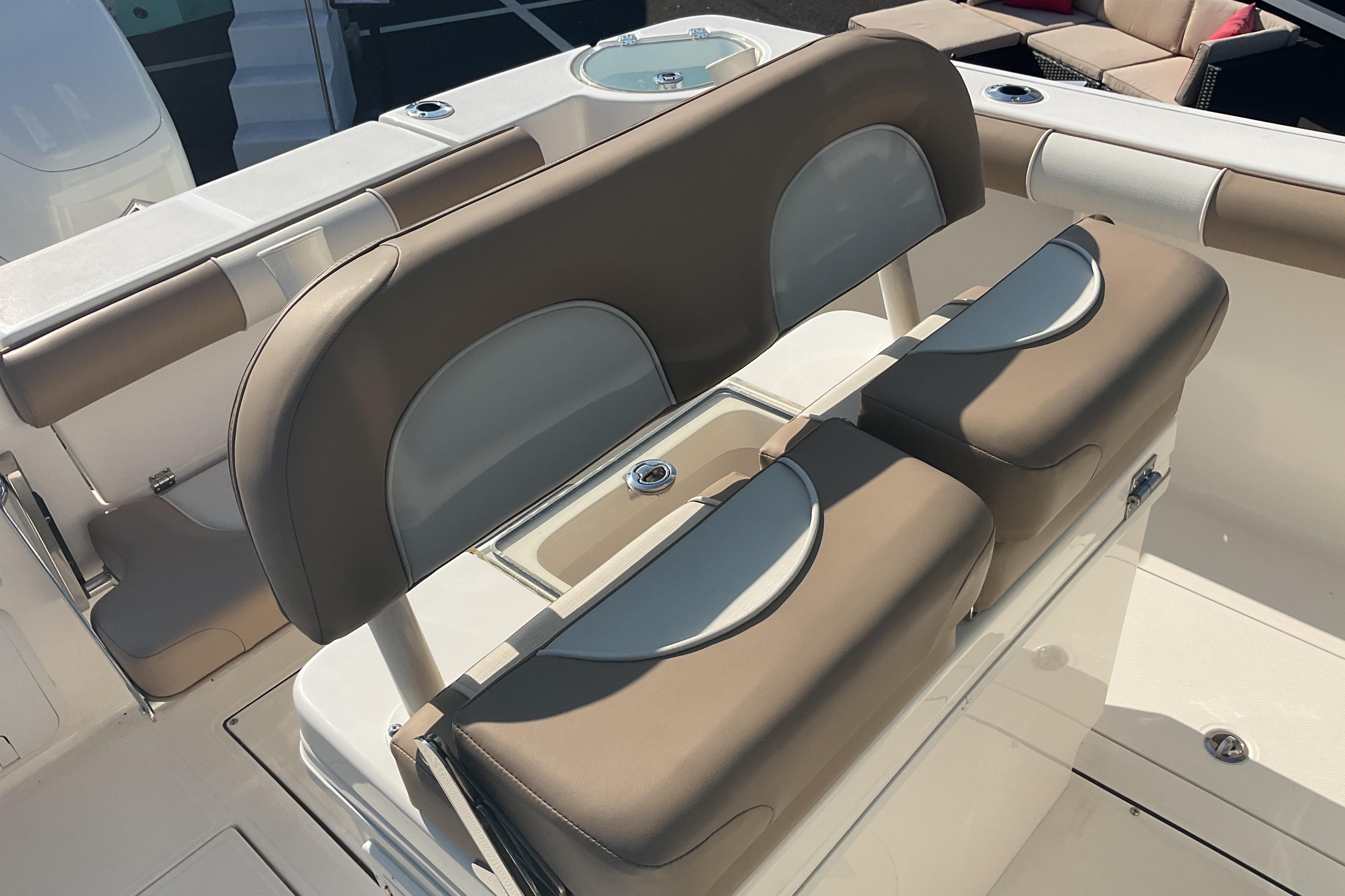 2023 Sea Born SX239 Offshore boat seating with storage and cup holders.