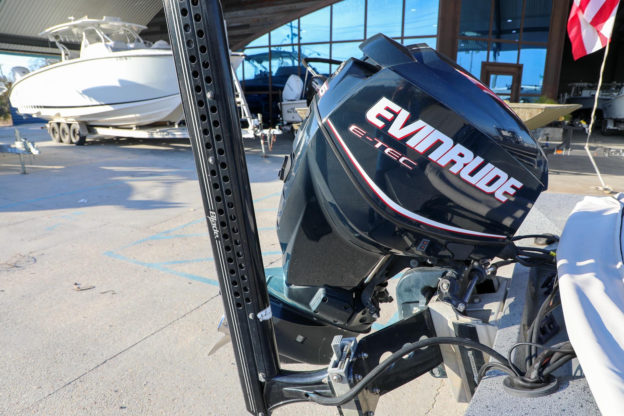 Outboard motor on Express 18 boat, 2019 model, in a marina setting.