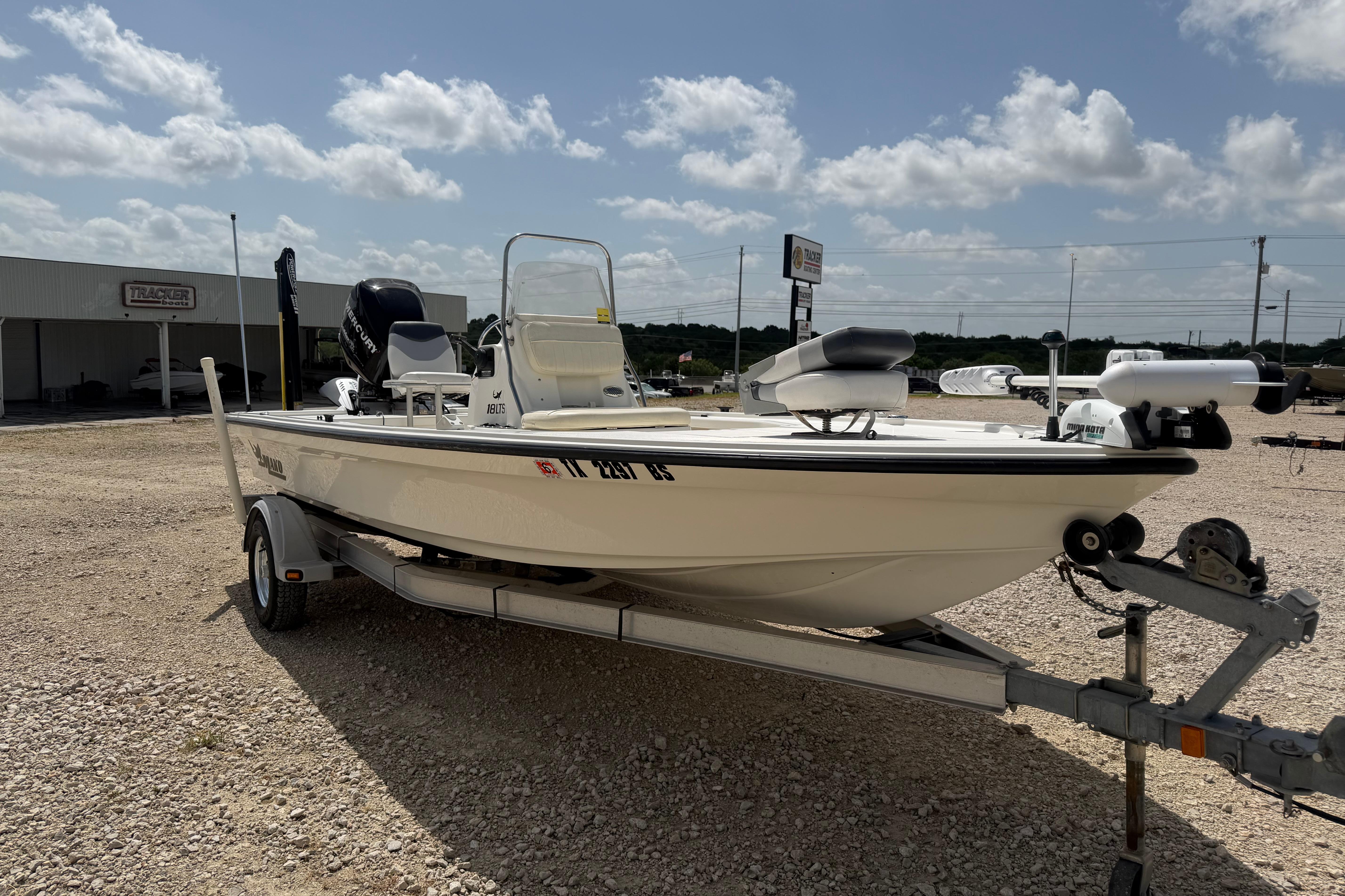 2012 Mako 18 LTS boat on trailer under a partly cloudy sky.