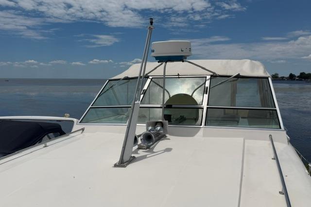 1980 Chris-Craft 381 Catalina boat on calm water under a clear sky.