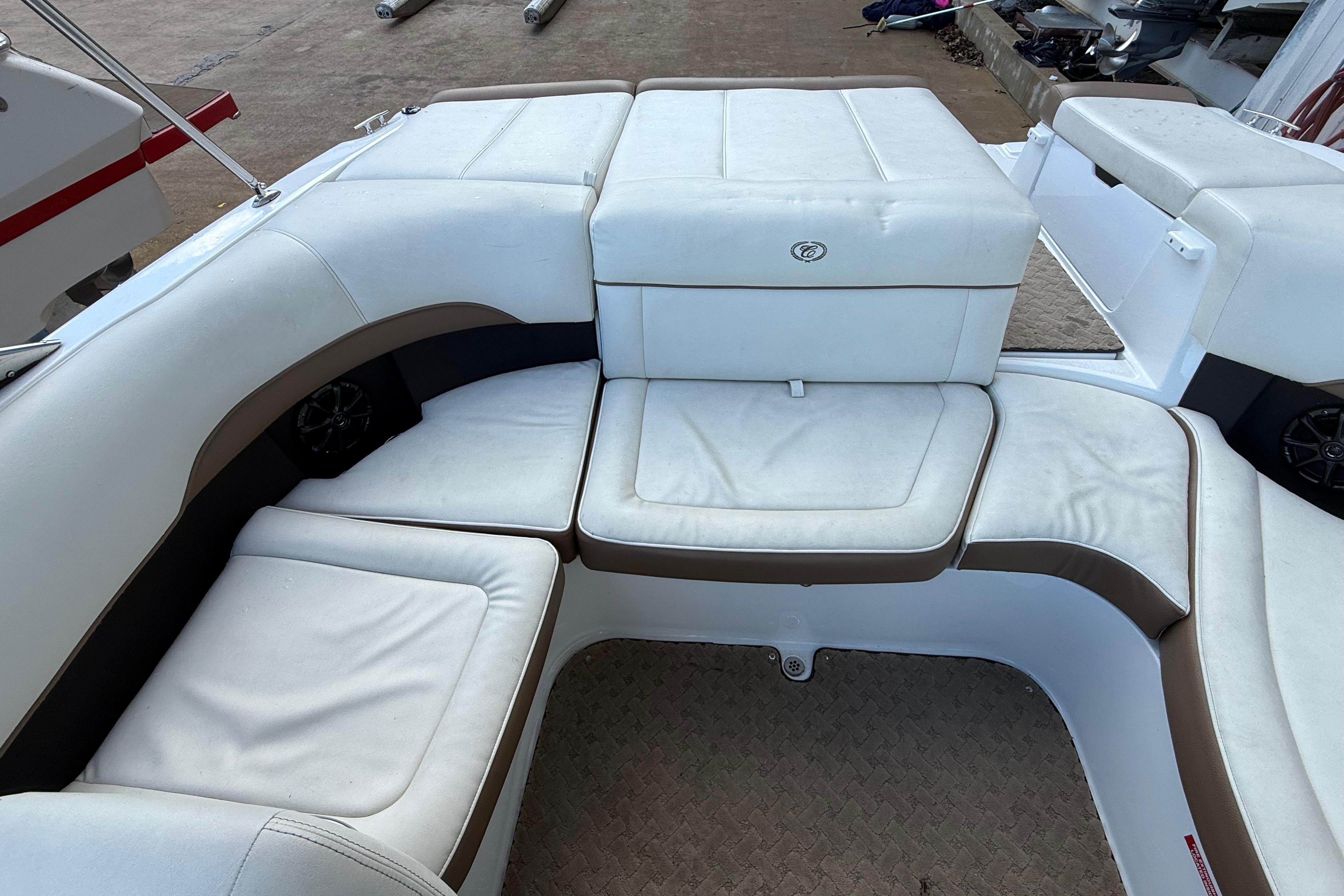 Cobalt 200 boat interior, 2015 model, featuring white cushioned seating and storage compartments.