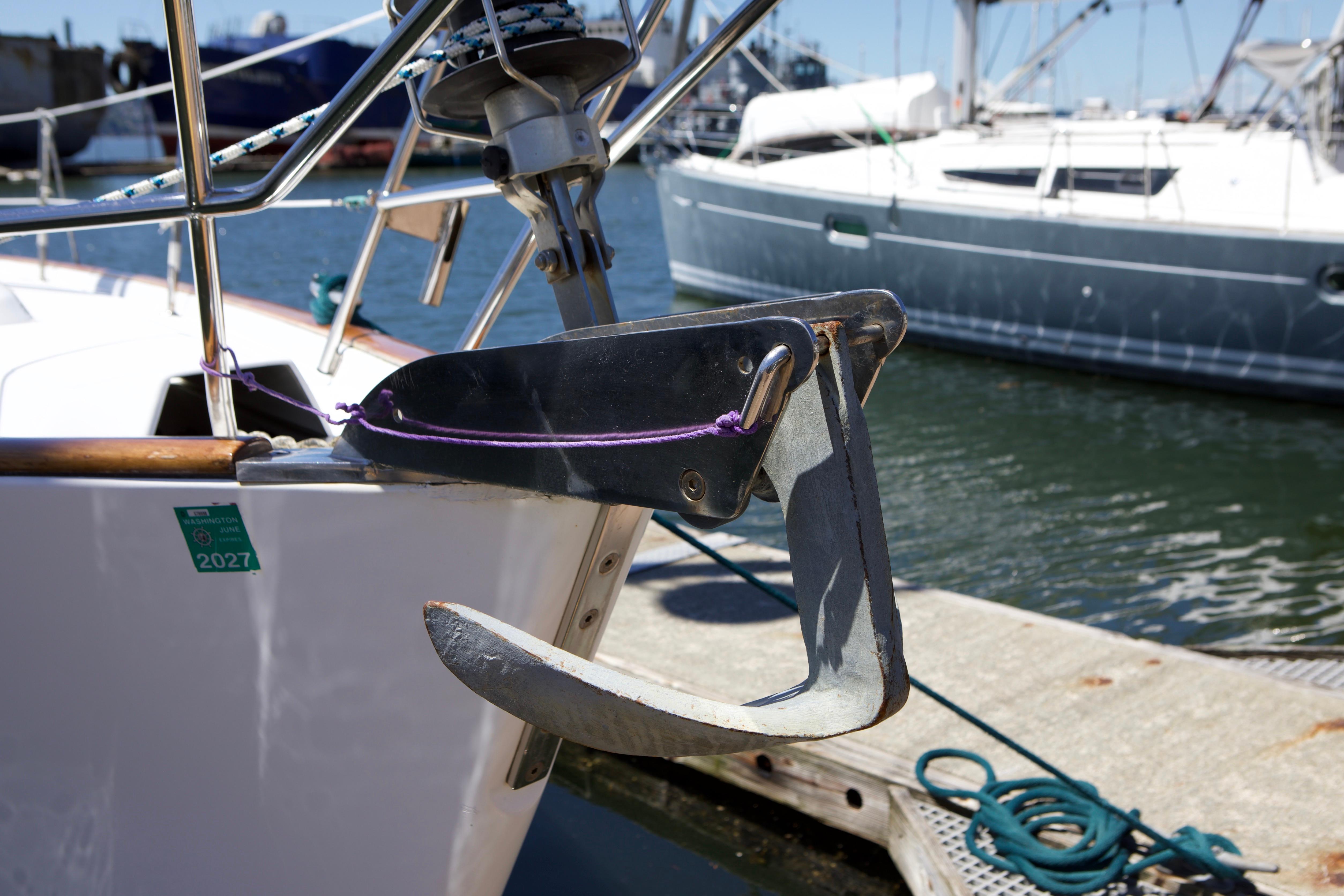 Bow anchor of a 2005 Beneteau 423 sailboat docked at a marina.