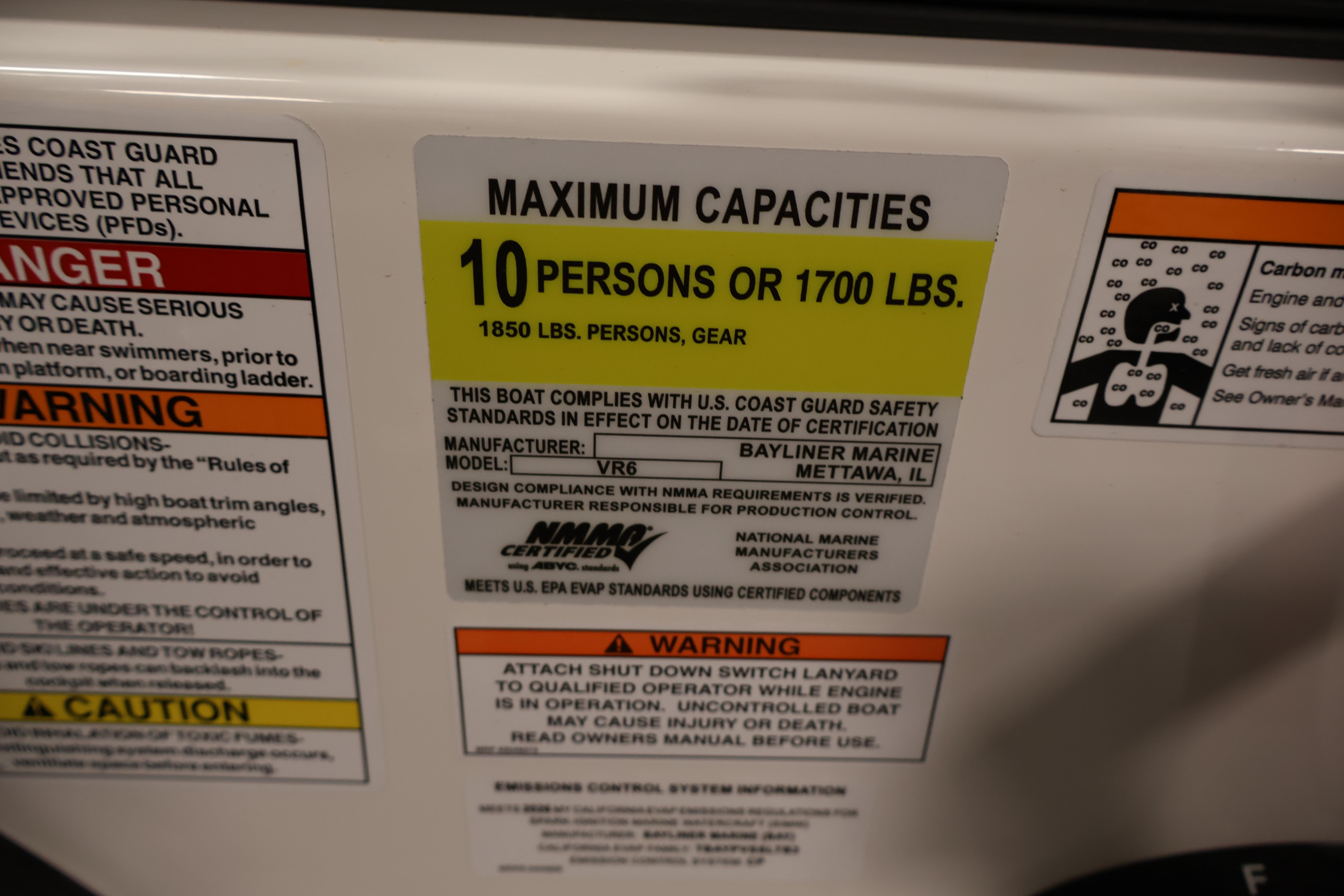 2026 Bayliner VR6 Bowrider I/O capacity label: 10 persons or 1700 lbs, safety warnings included.