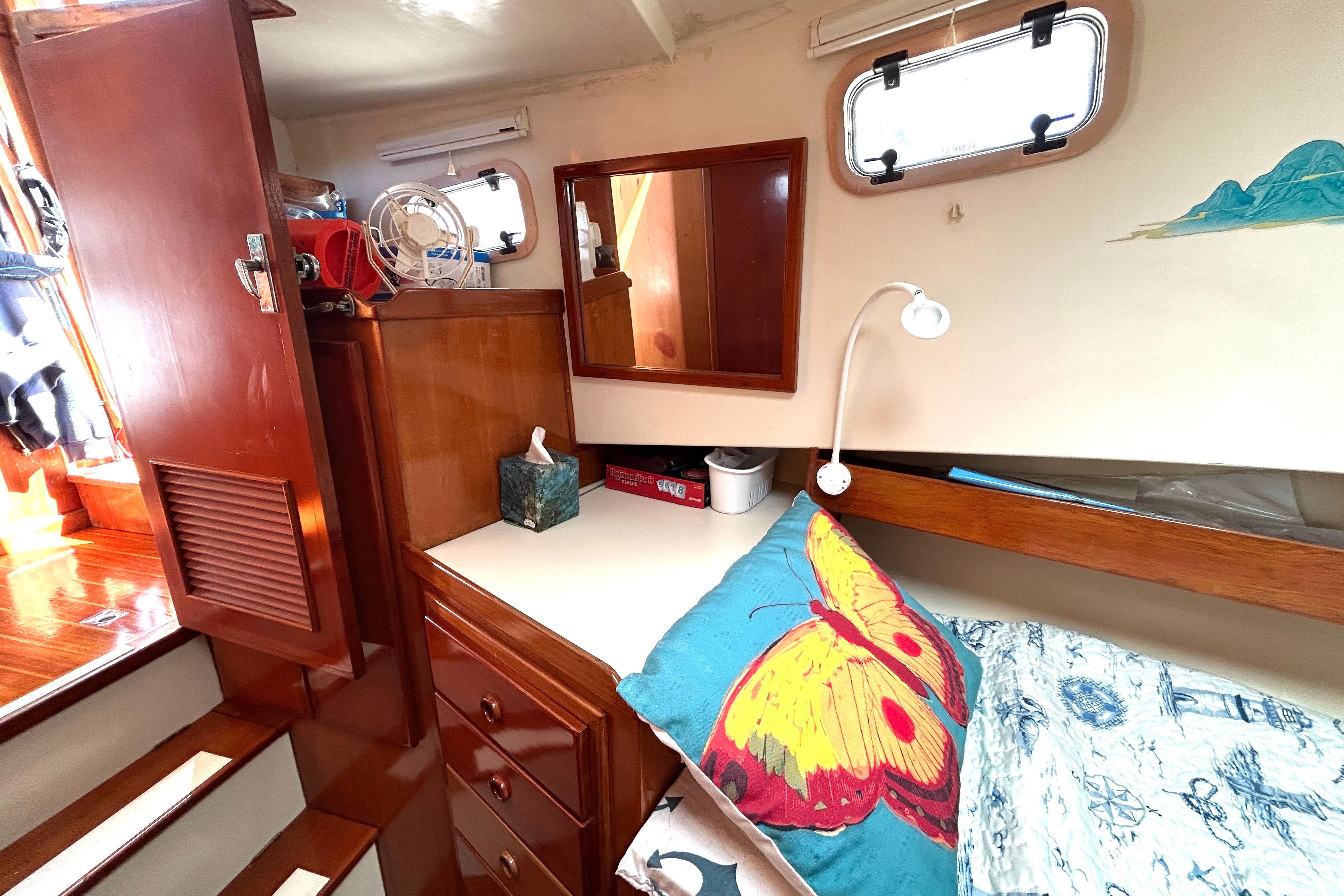 Cozy cabin interior of 1987 Transpacific Marine Eagle 32 Trawler with colorful butterfly pillow.