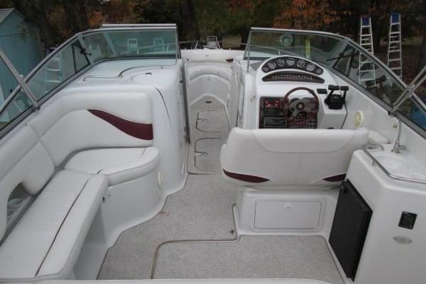 2004 Crownline 288 BR boat interior with white seating and modern dashboard.
