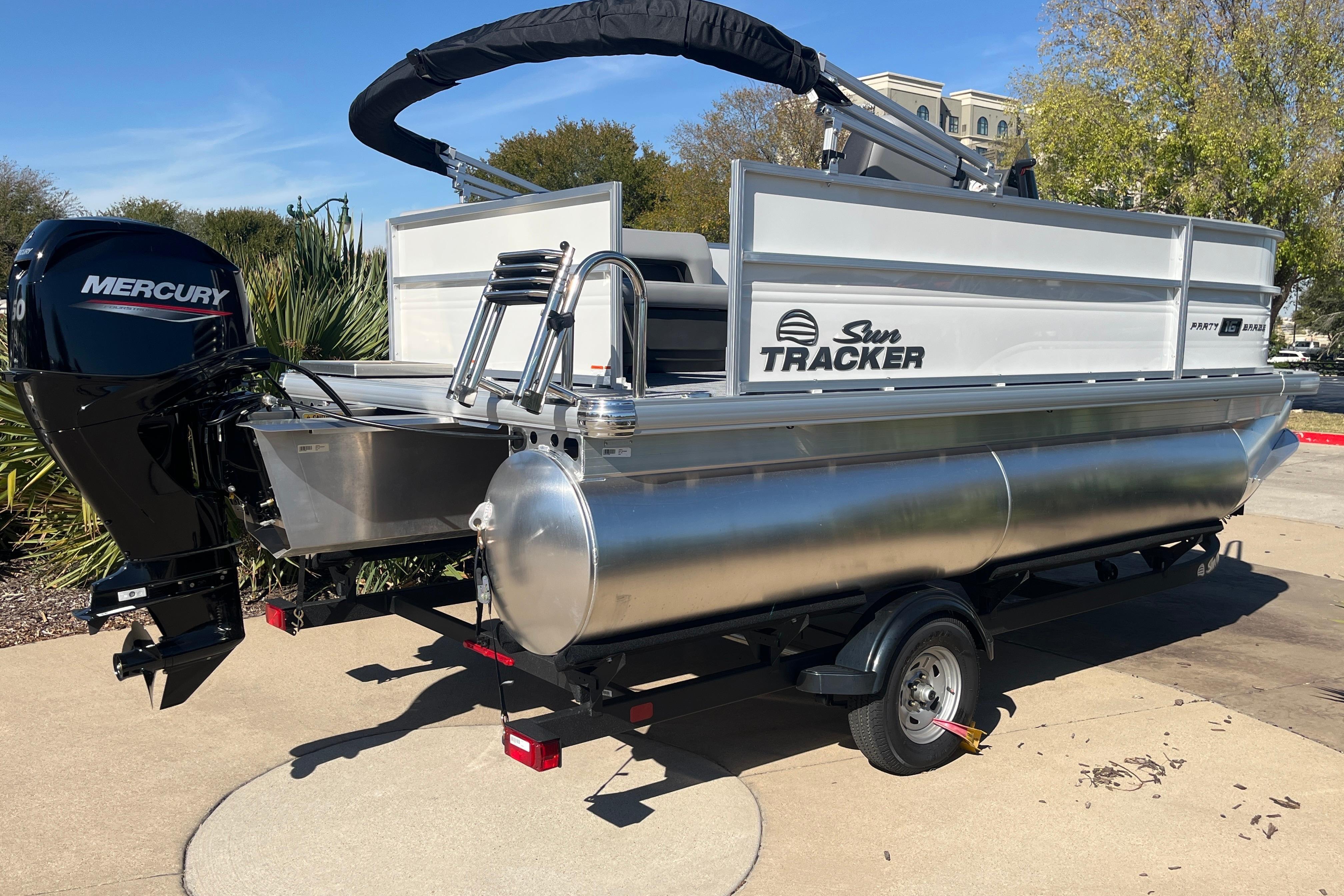 2026 Sun Tracker Party Barge 16 DLX pontoon boat with Mercury engine on trailer.