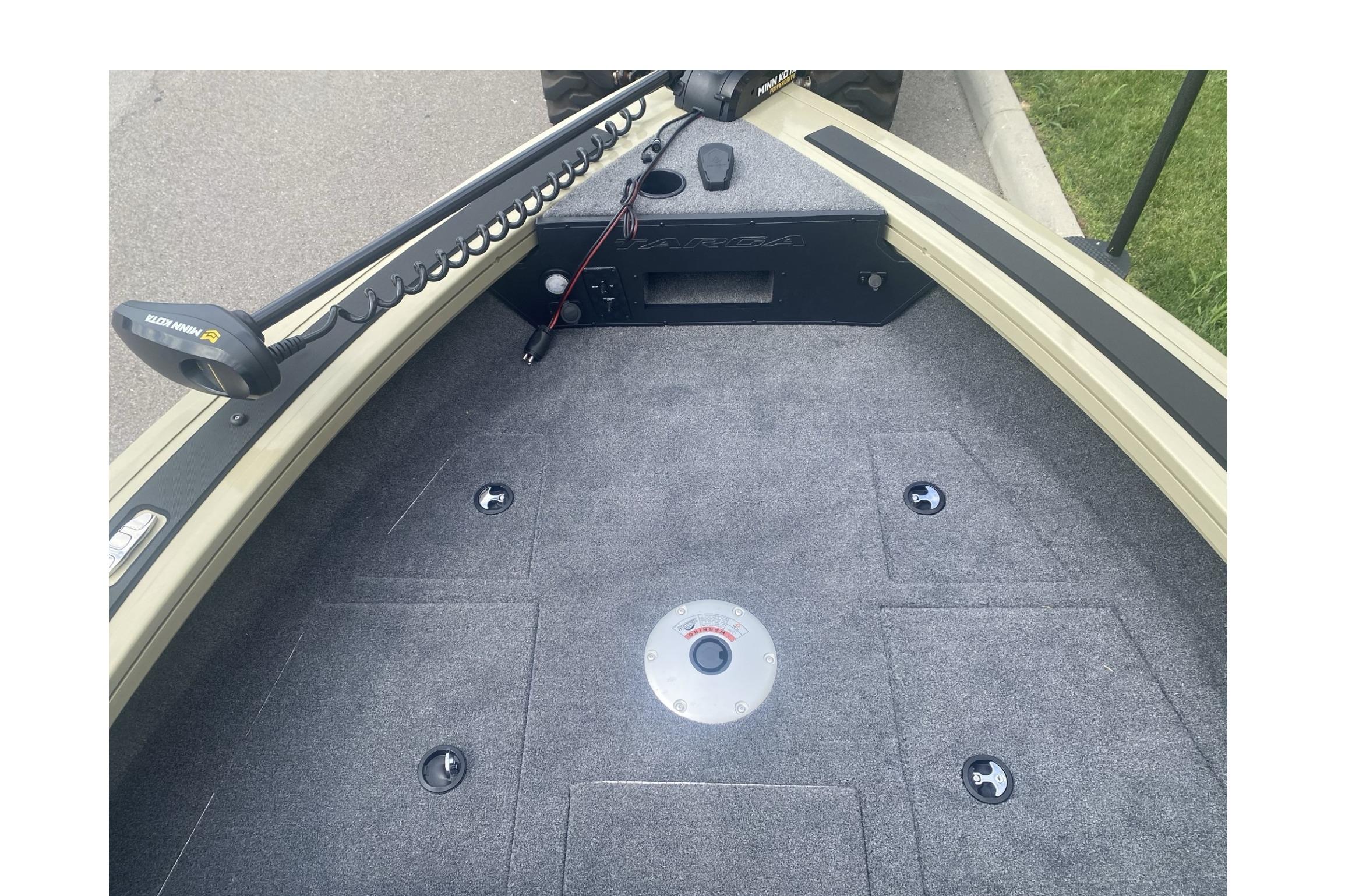 2026 Tracker Targa V-19 WT boat deck with trolling motor and carpeted surface.