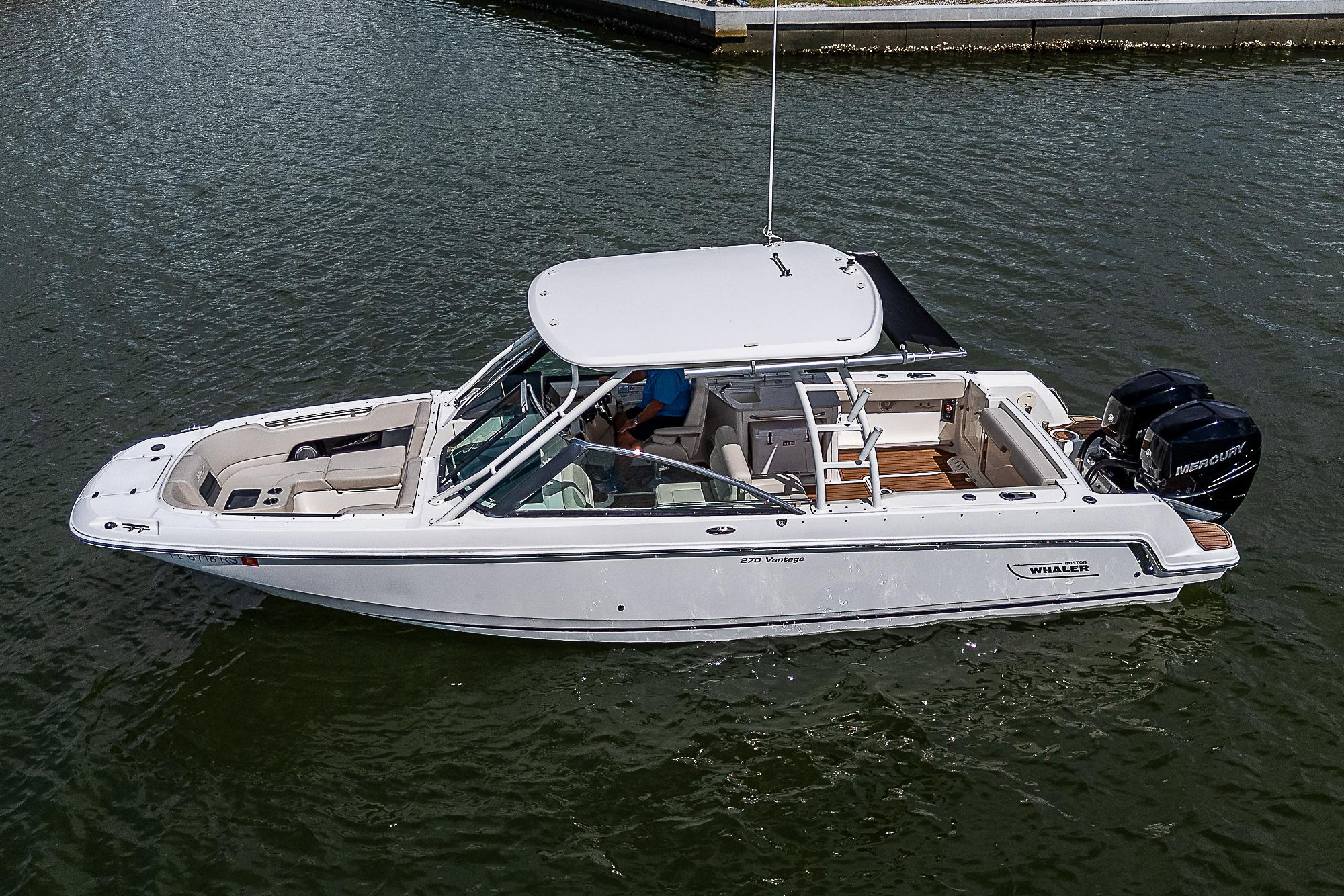 2018 Boston Whaler 270 Vantage boat on water, side view.