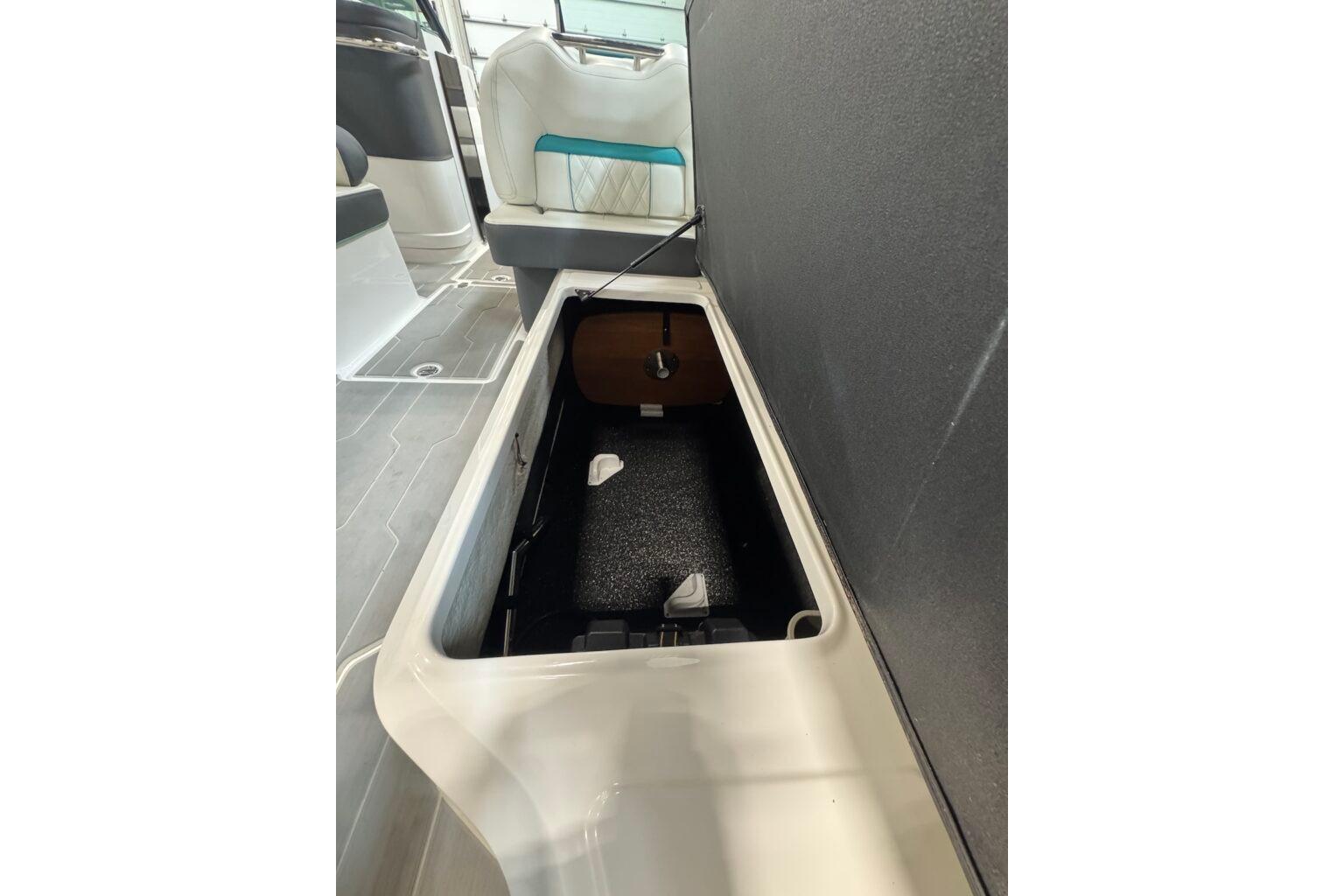 2022 Regal LS6 Surf boat interior storage compartment, open and empty.