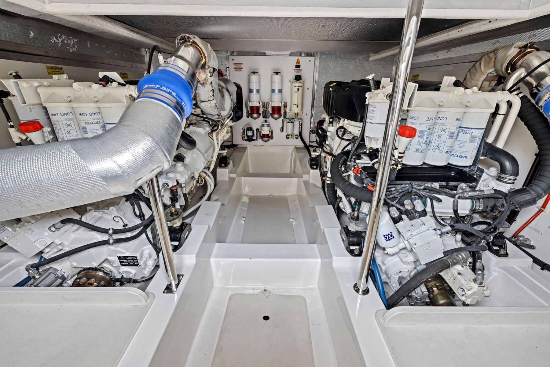 Engine room of 2014 Maritimo M50 yacht, showcasing dual engines and mechanical components.