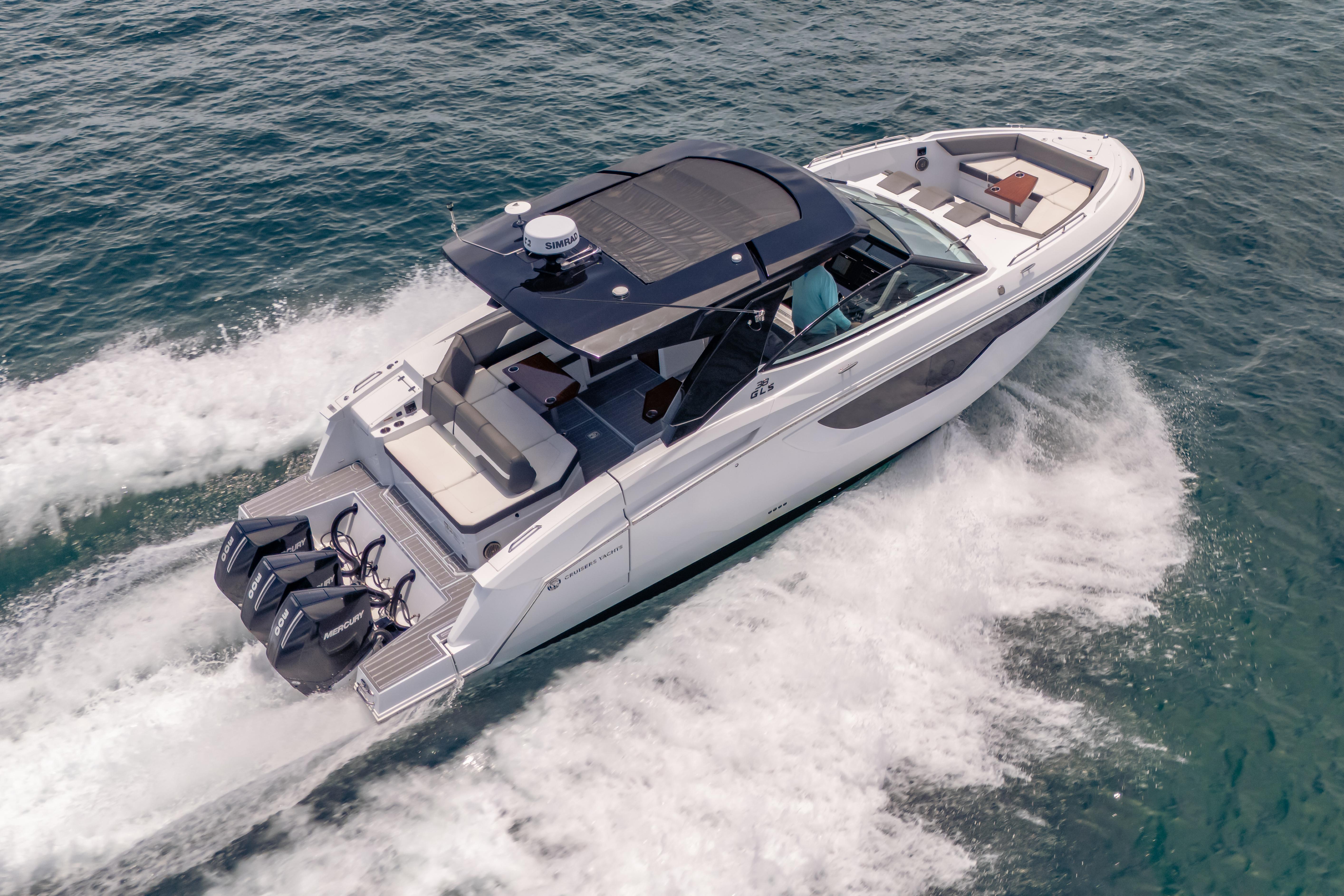 2021 Cruisers Yachts 38 GLS speeding on open water, showcasing sleek design and powerful engines.