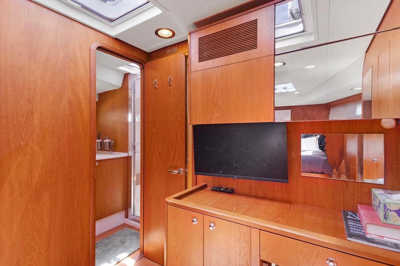 Interior of 2011 Southerly 57 RS yacht with wooden cabinetry and modern amenities.
