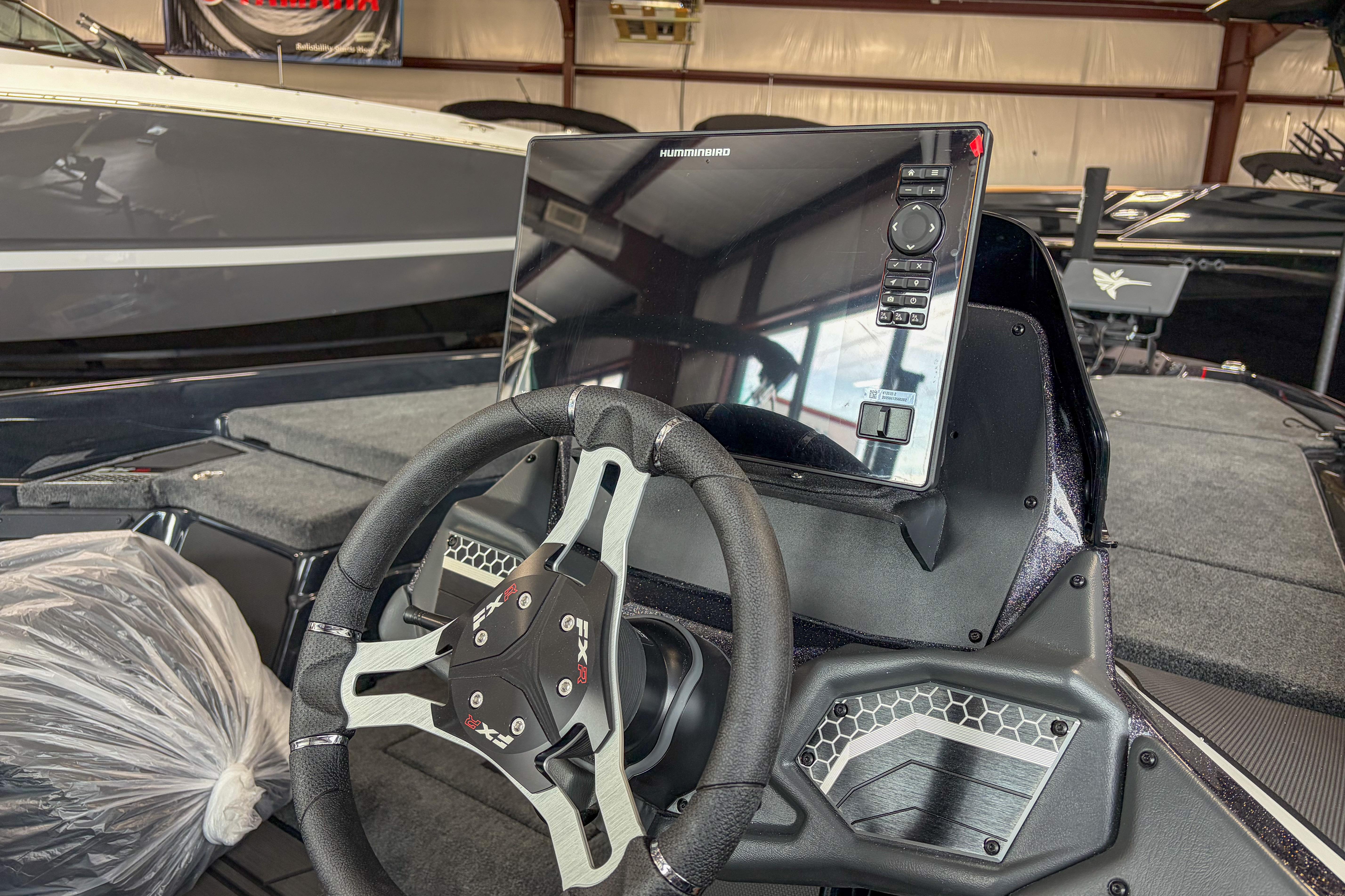 2026 Skeeter FXR20 FLEX boat dashboard with steering wheel and electronic display.