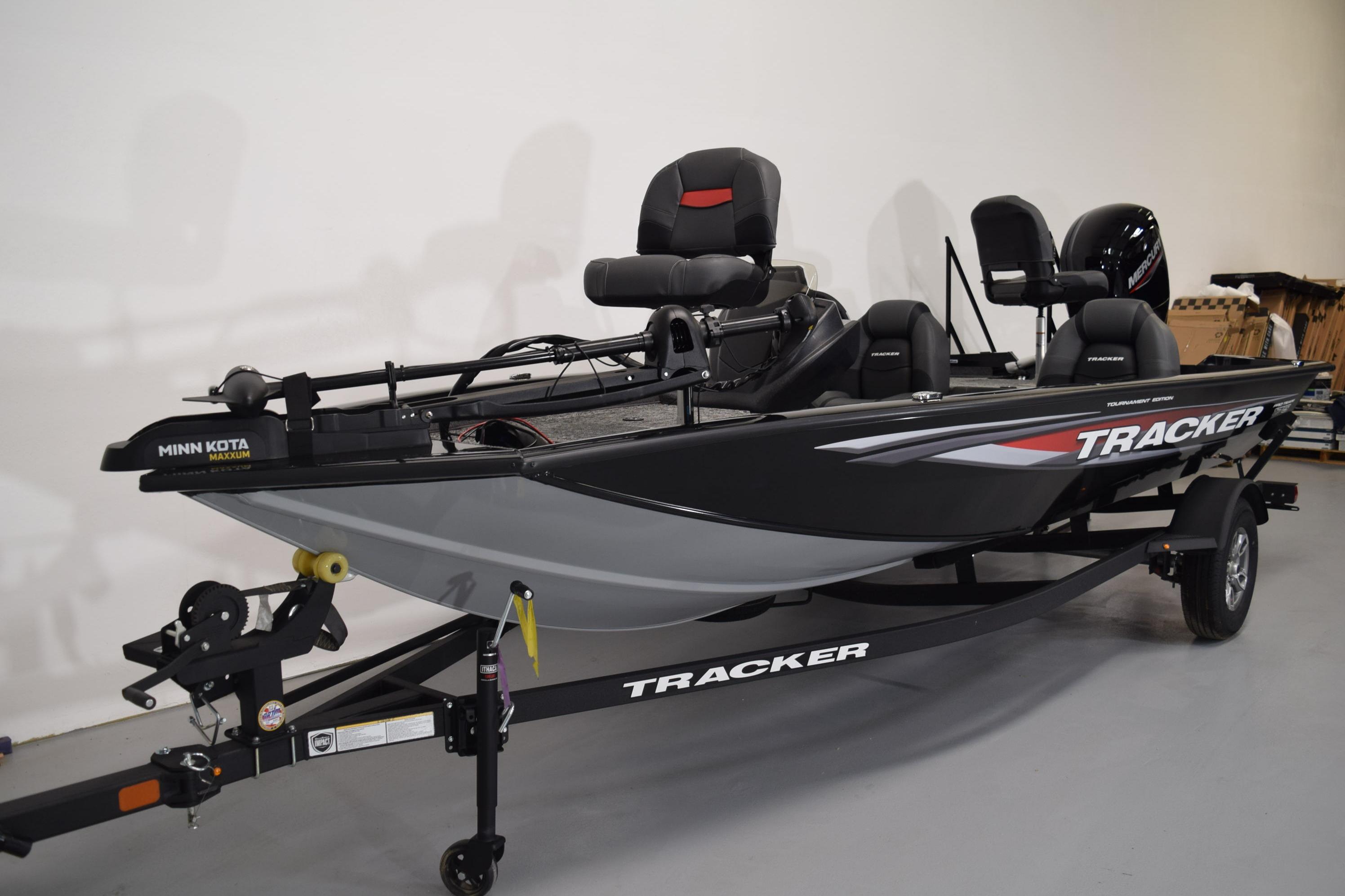 2026 Tracker Pro Team 175 fishing boat on trailer in showroom.
