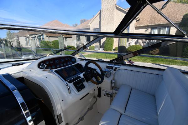 1997 Sunseeker Camargue 47 cockpit with steering wheel, control panel, and white seating.