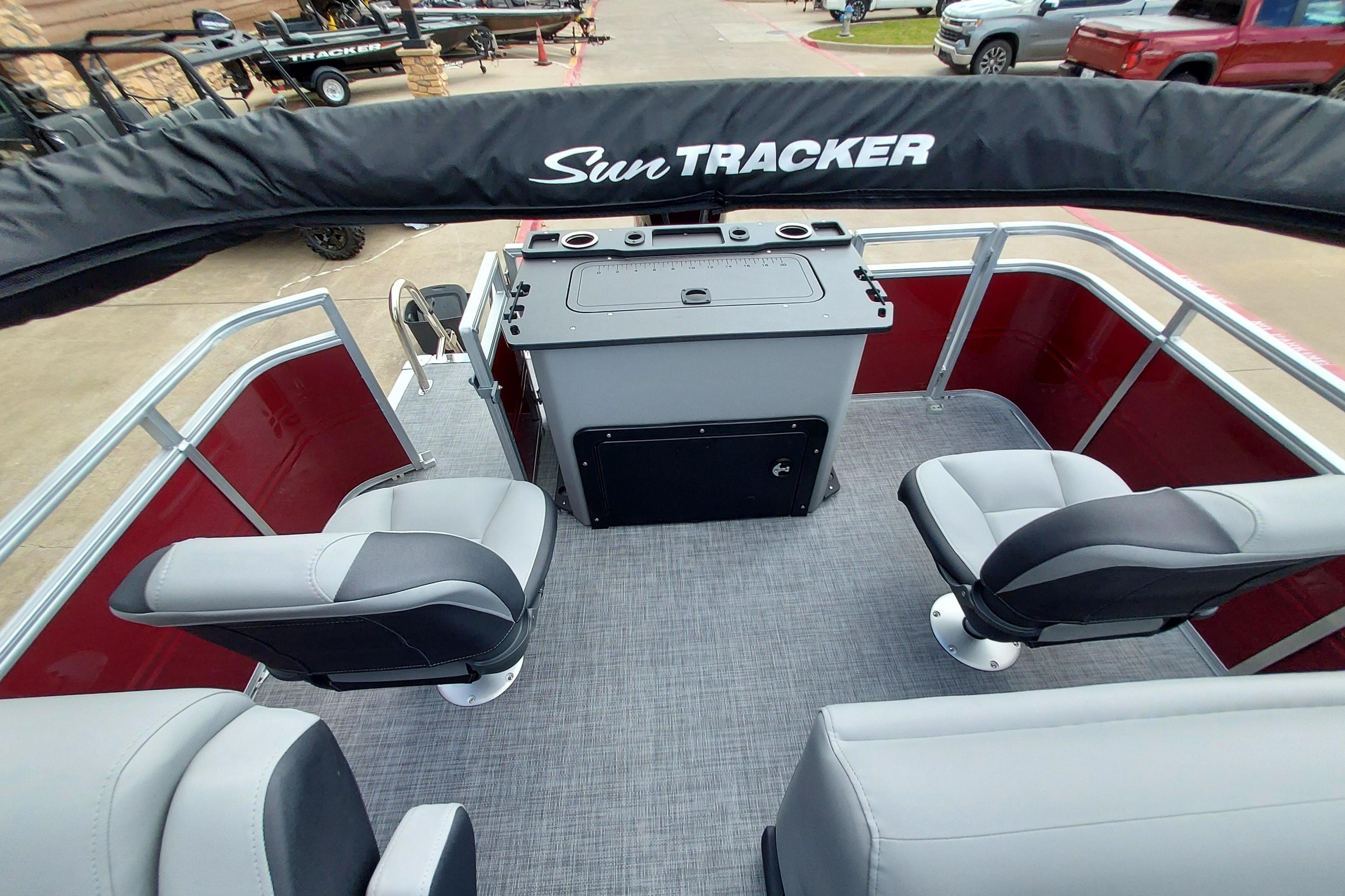 2026 Sun Tracker SportFish 20 DLX pontoon boat interior with seating and control panel.