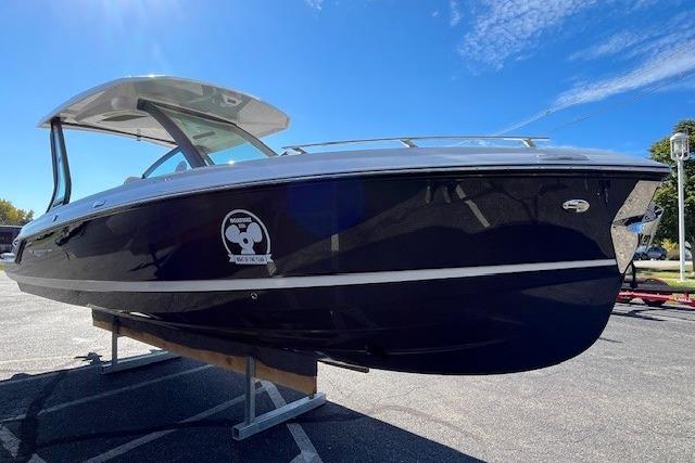 2026 Monterey Elite 27 SD boat on display under clear blue sky.