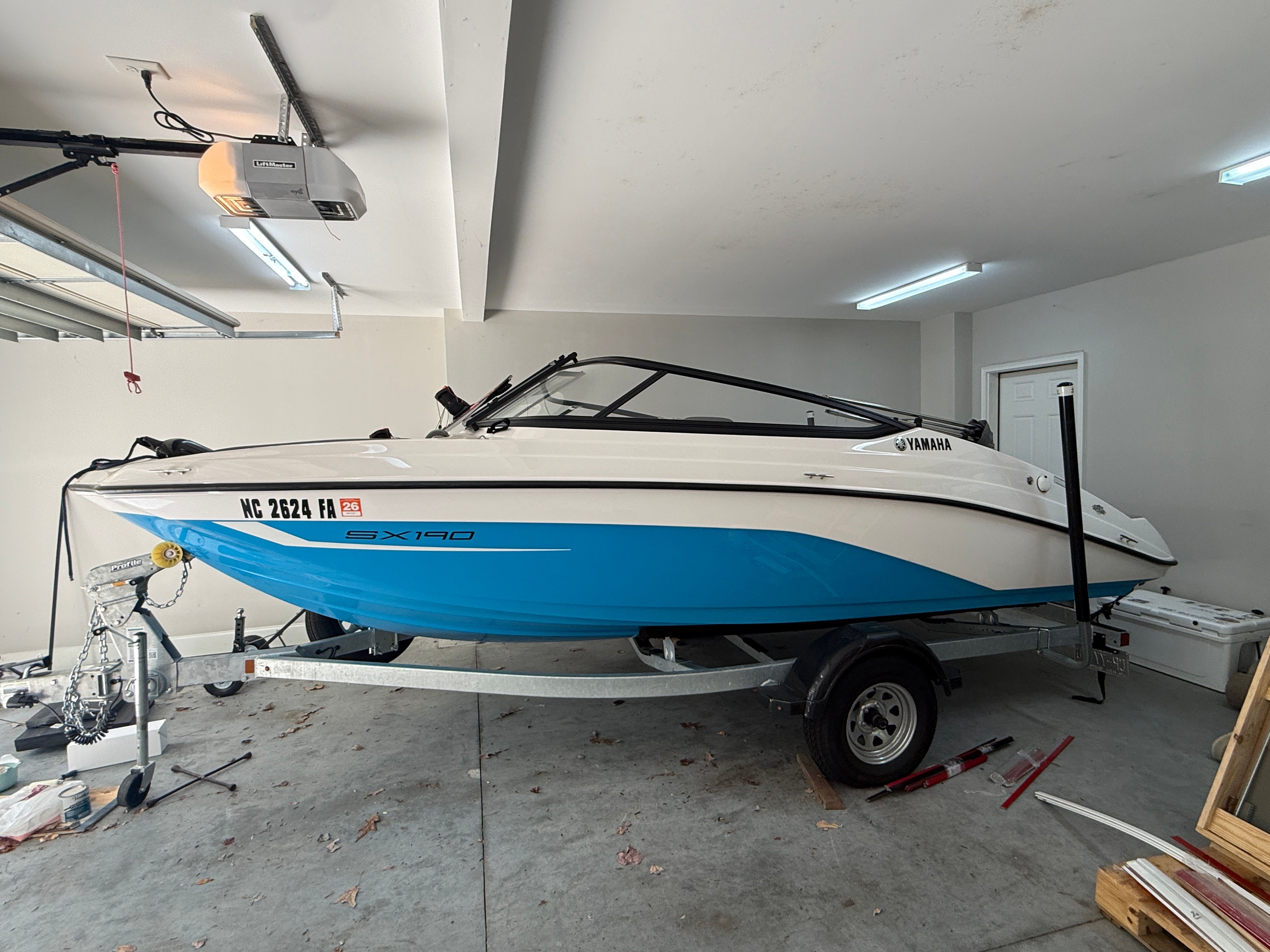 2023 Yamaha SX190 boat in a garage on a trailer.