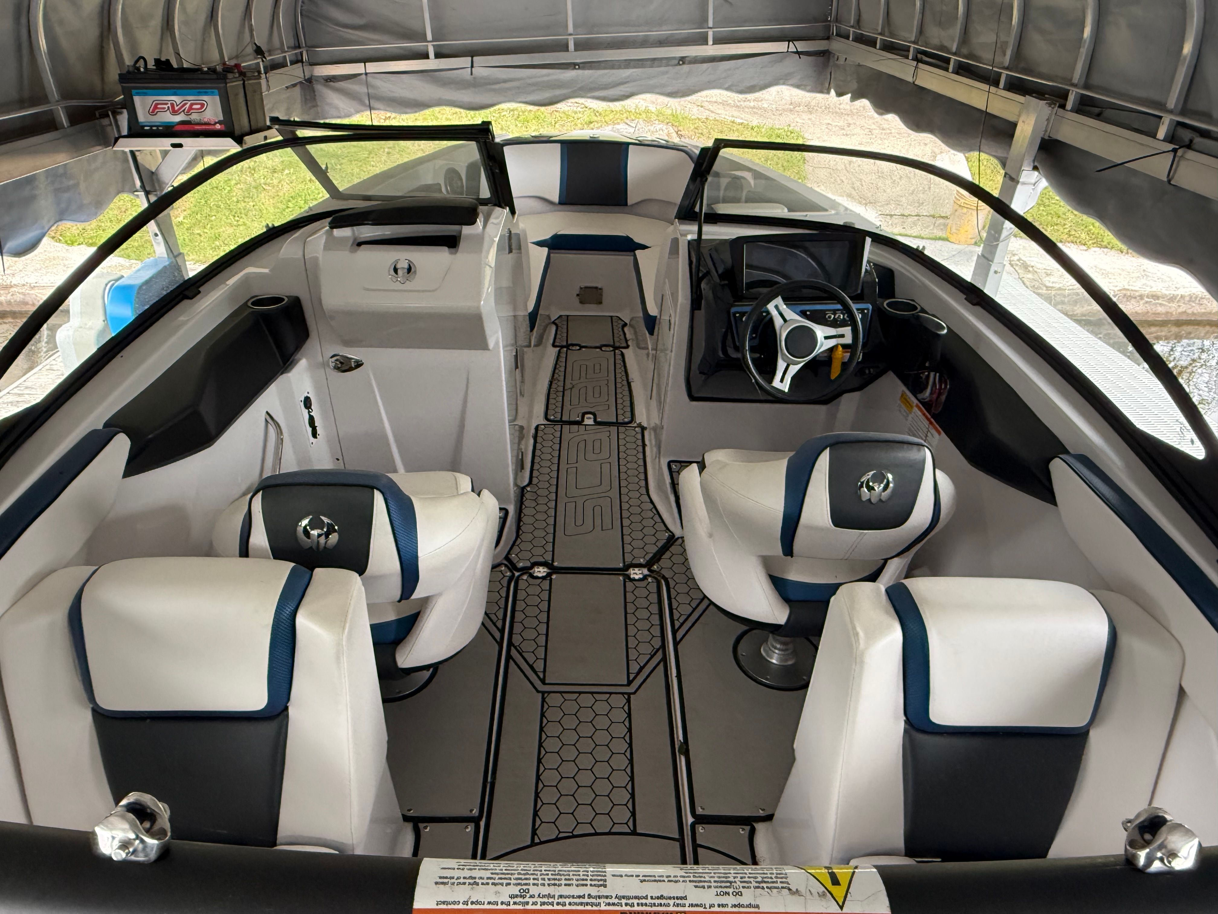 Interior view of a 2018 Scarab 255 HOI boat with white and blue seating.