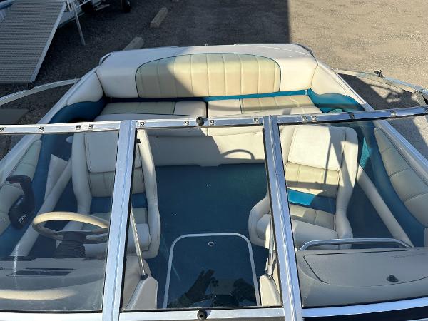 1995 Larson 174 SEI boat interior with white and teal seating, viewed from above.