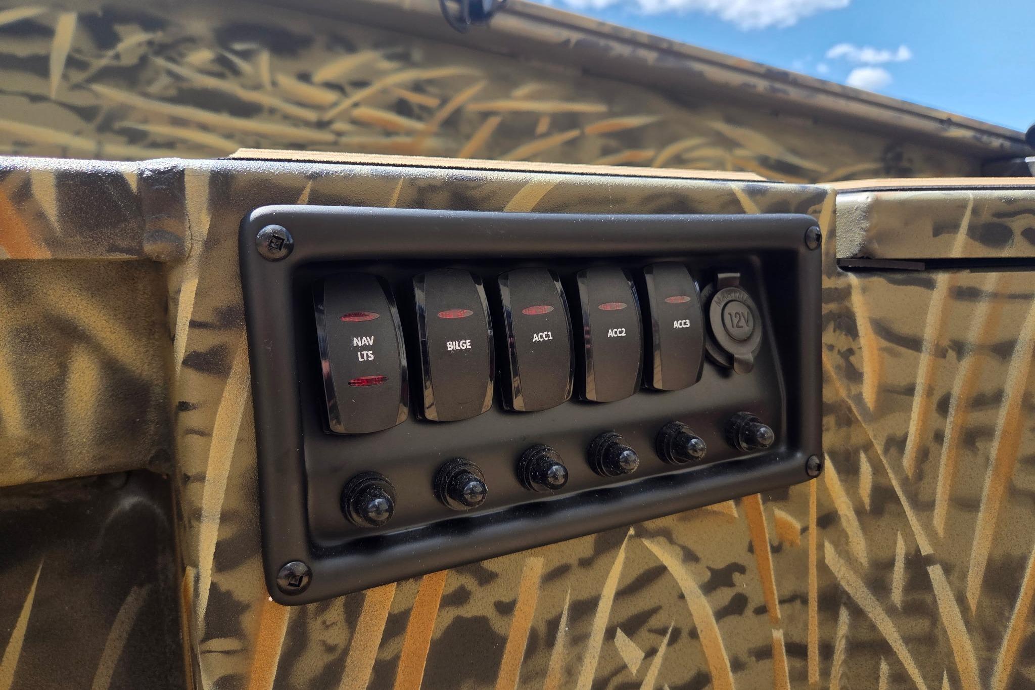 Control panel of 2026 Tracker Grizzly 1756 T Marsh boat with camo design.