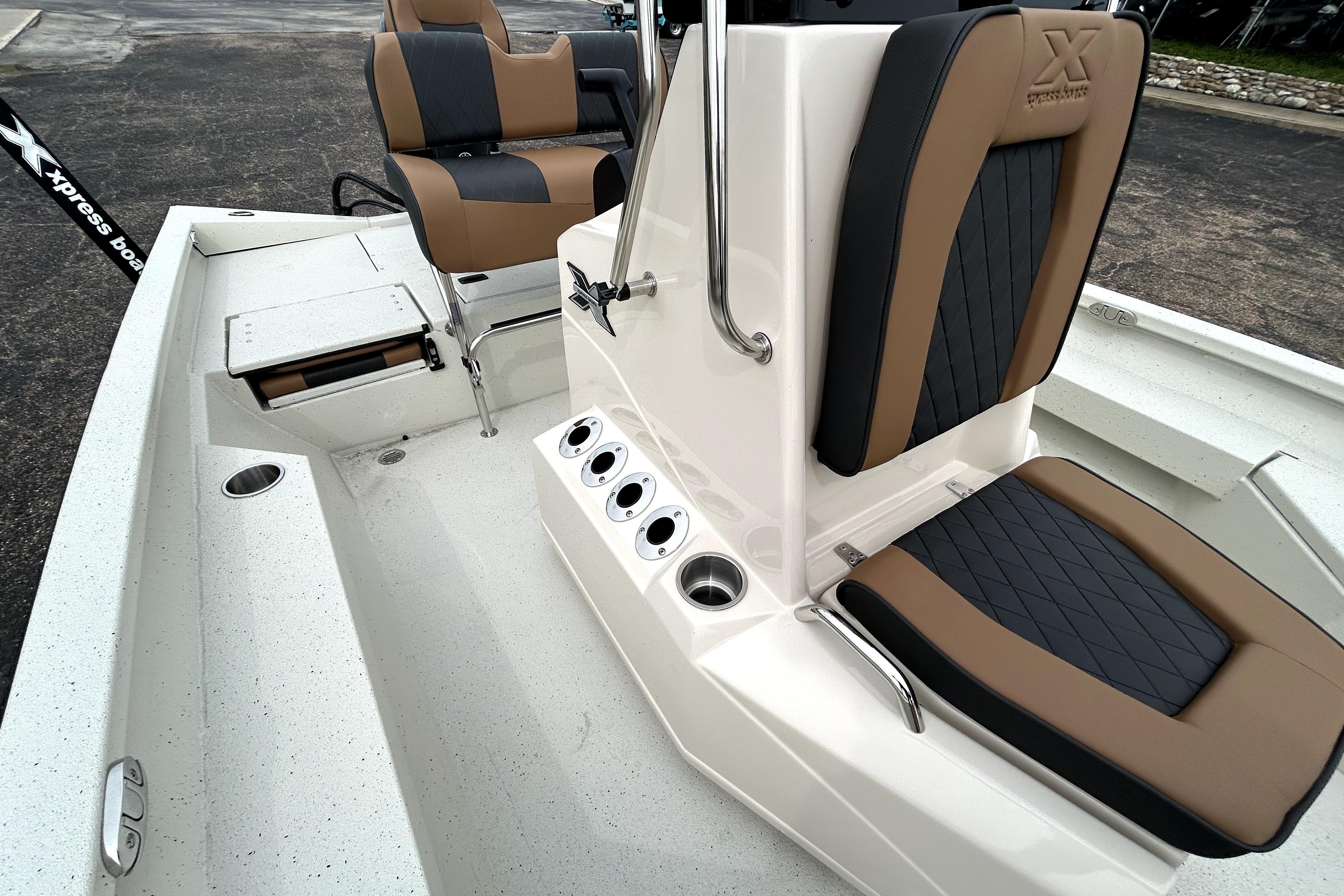 2026 Xpress H20B Bay boat interior with cushioned seating and console details.