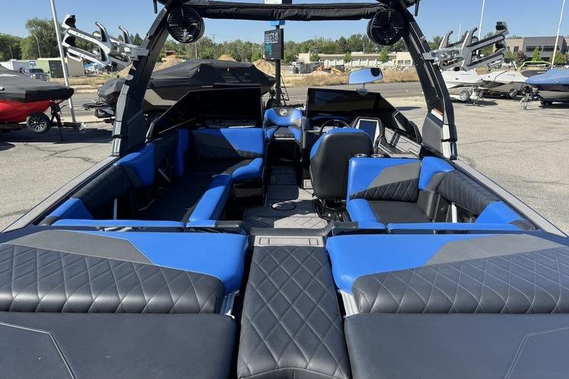 2022 Tigé Z3 boat interior with blue and black seating, parked outdoors.