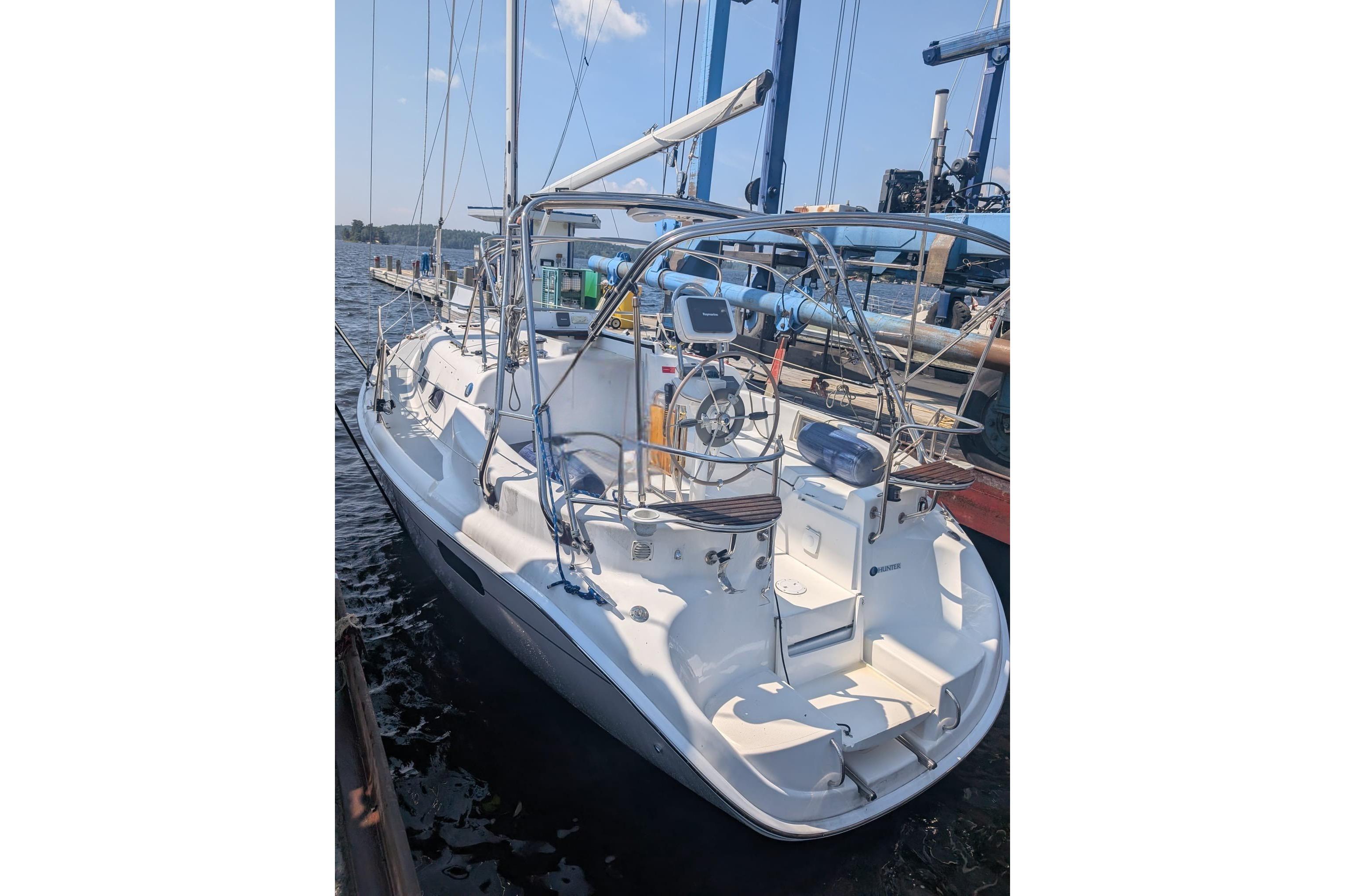2004 Hunter 306 sailboat docked, featuring a spacious cockpit and sleek design.