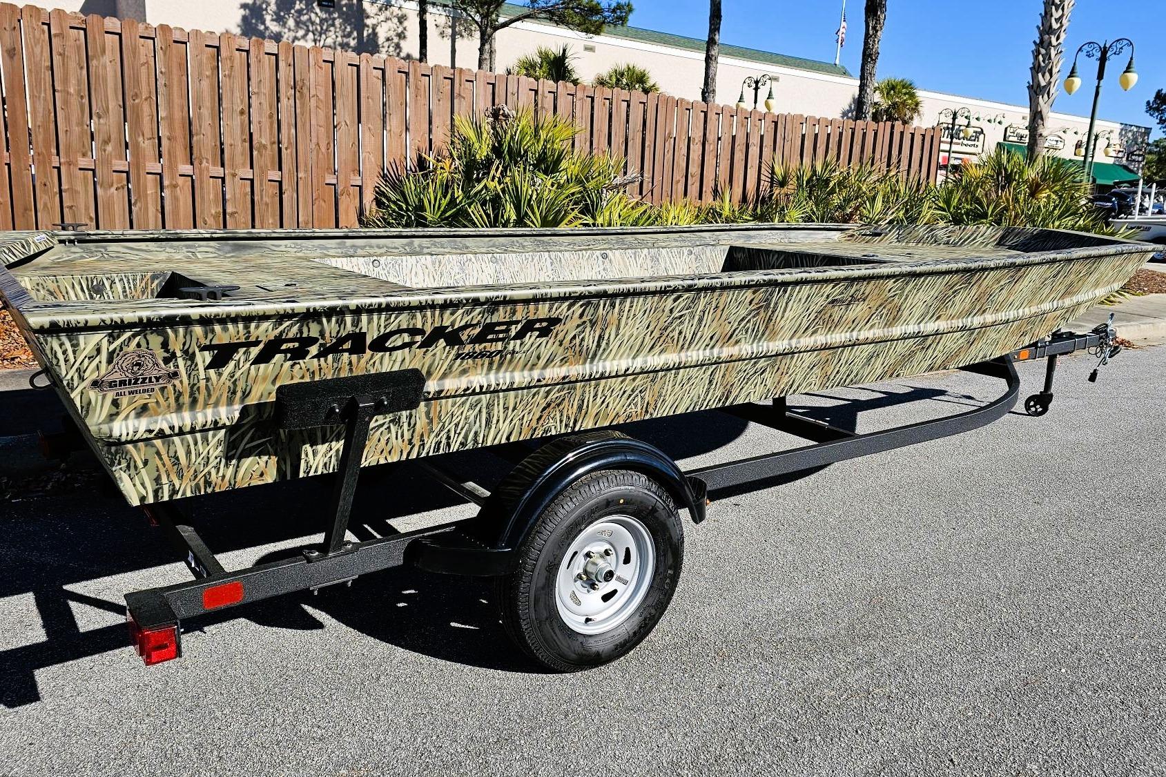 2025 Tracker Grizzly 1860 Utility boat with camouflage design on a trailer.