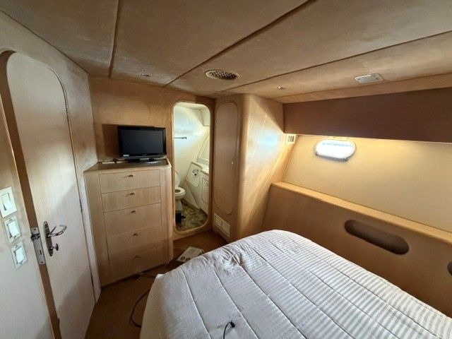 Interior of a 1990 custom motor yacht with bedroom and bathroom.
