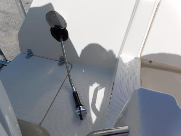 2024 Sailfish 242 CC boat deck with fuel hose and compartment.